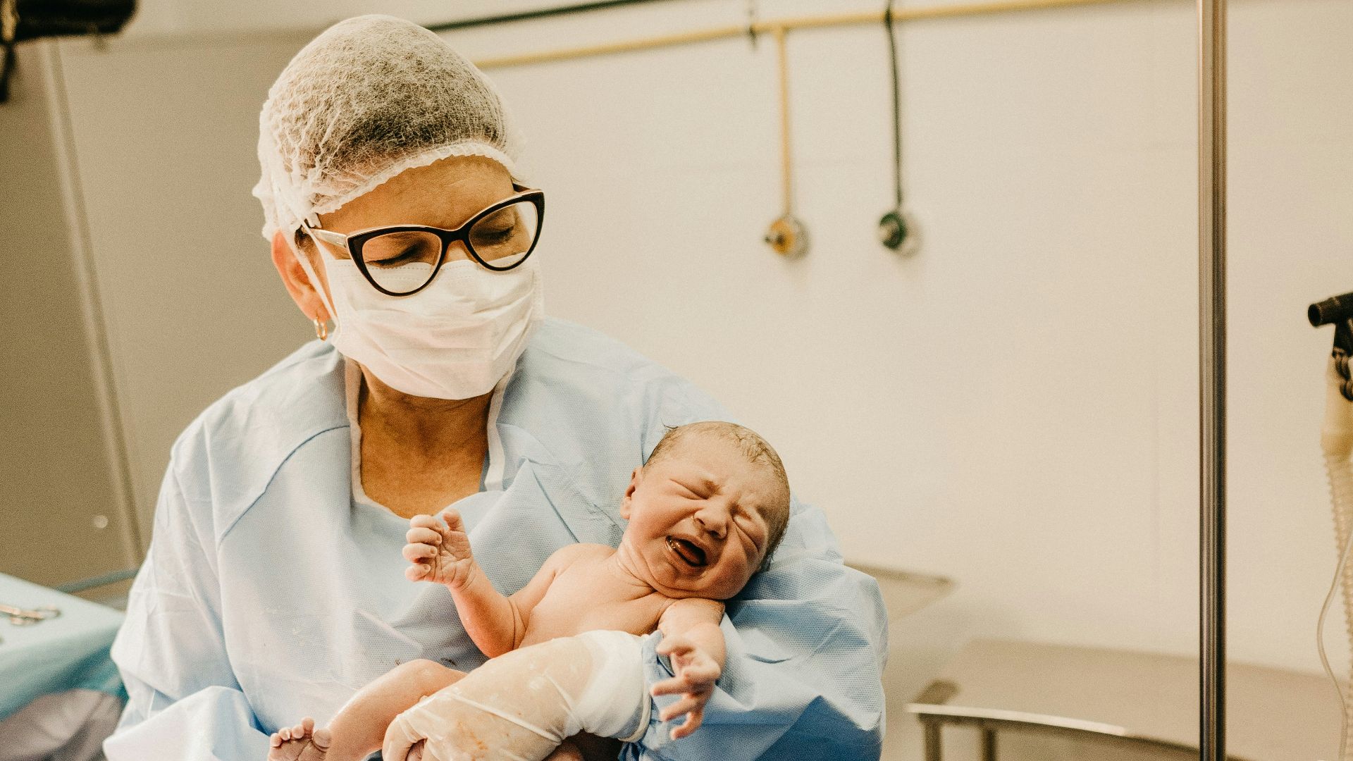 shallow focus photo of person carrying topless baby