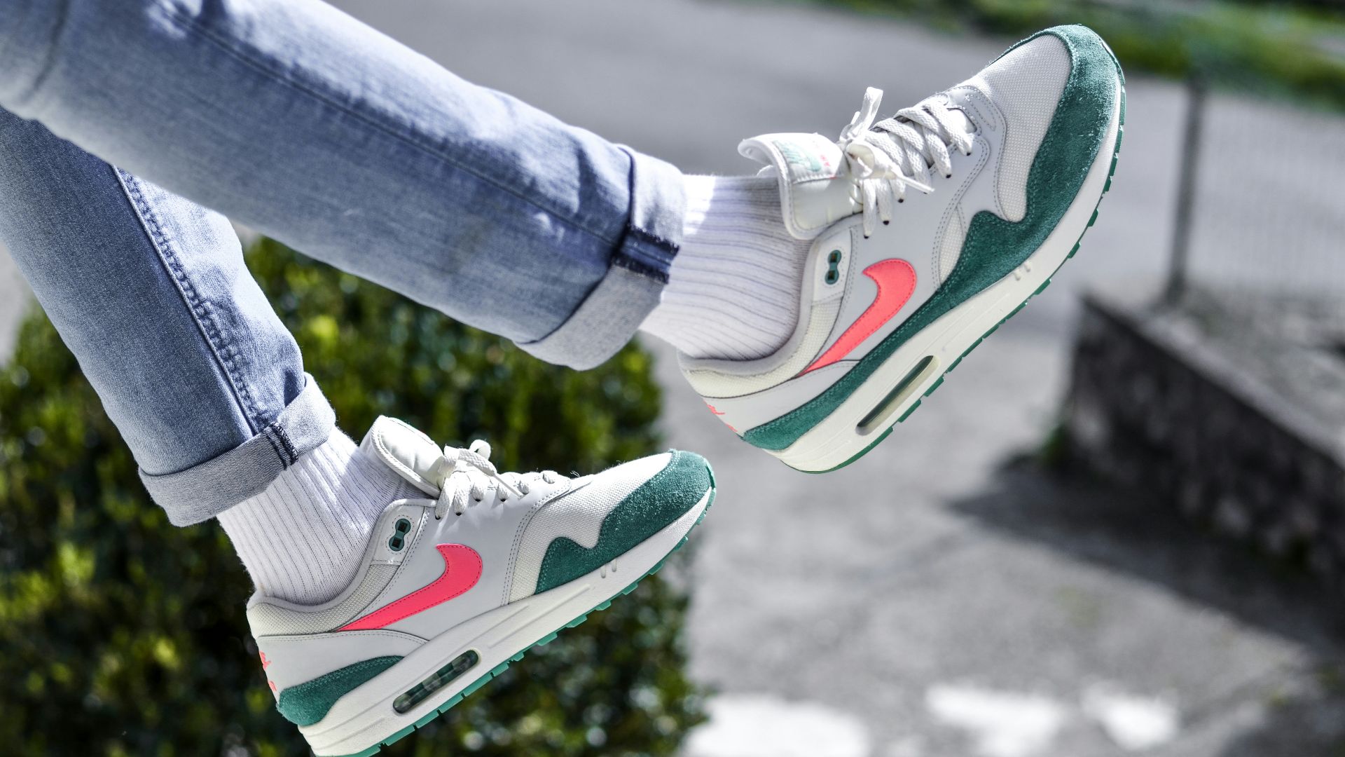 person in blue denim jeans and white nike sneakers