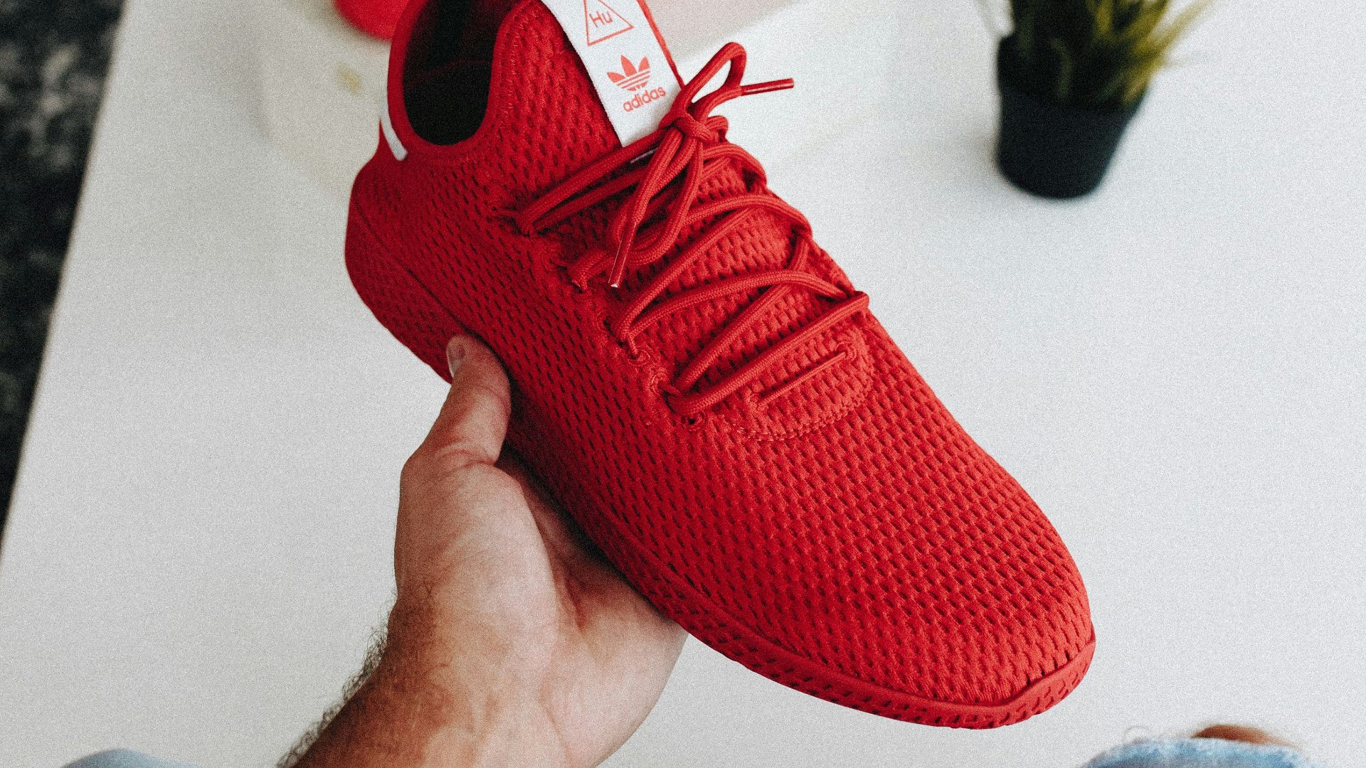 pair of red Adidas low-top shoes