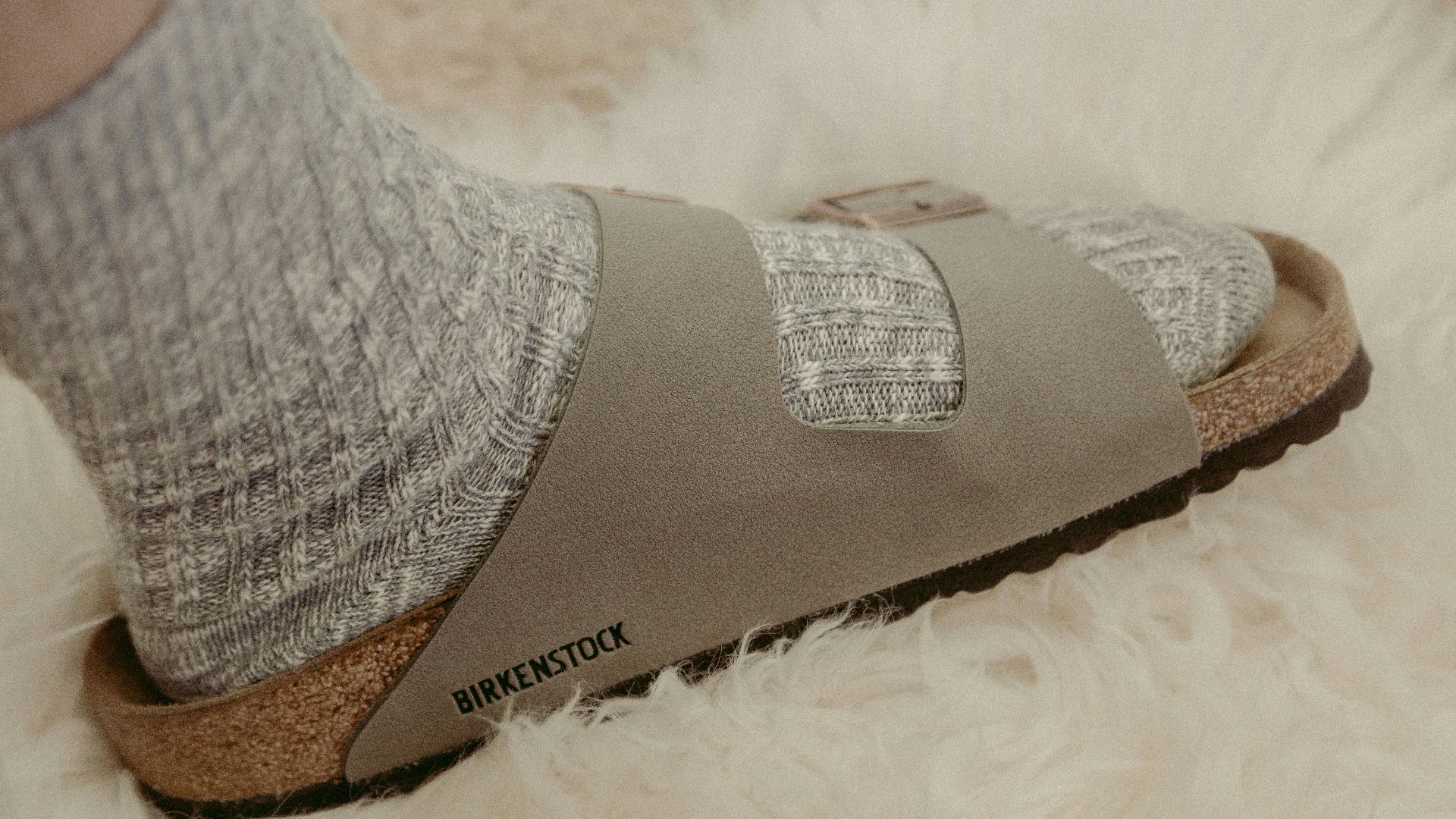gray and brown sock on white textile