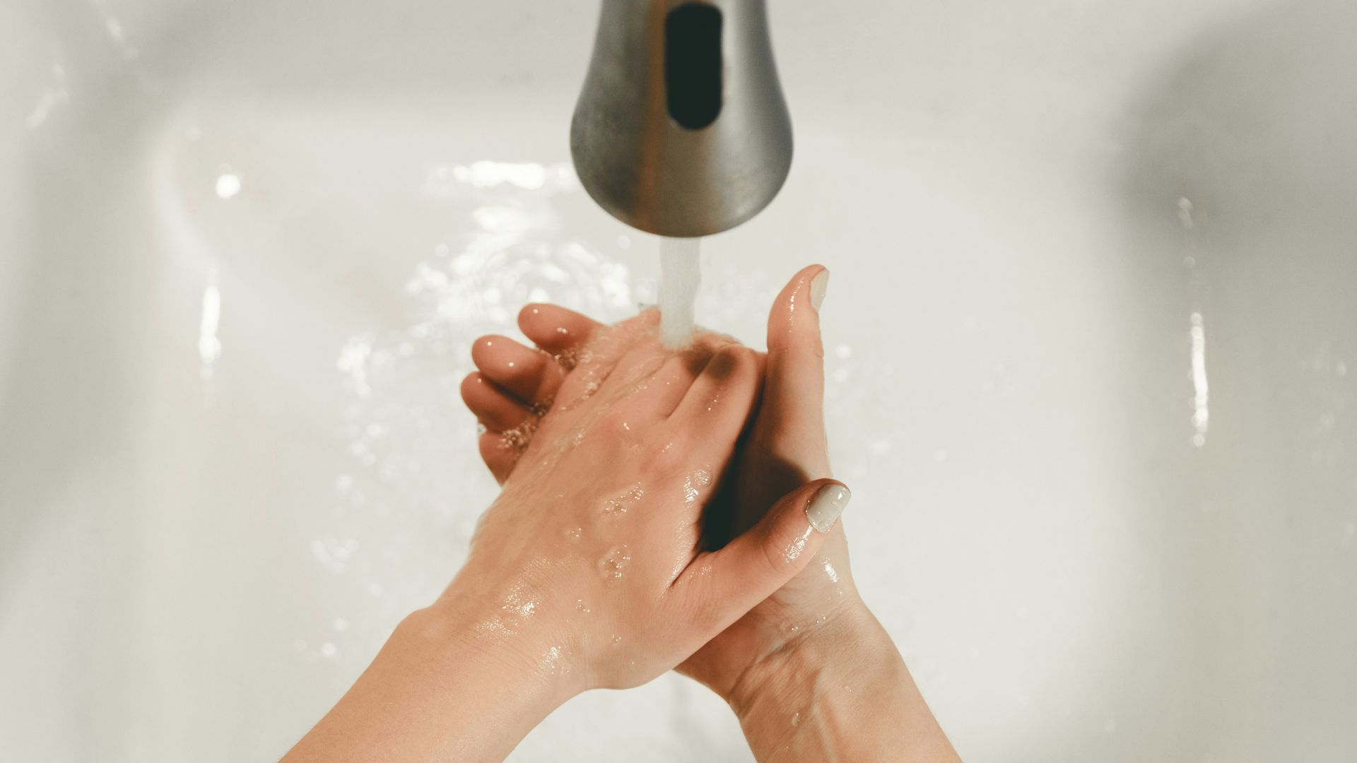 persons feet on white bathtub