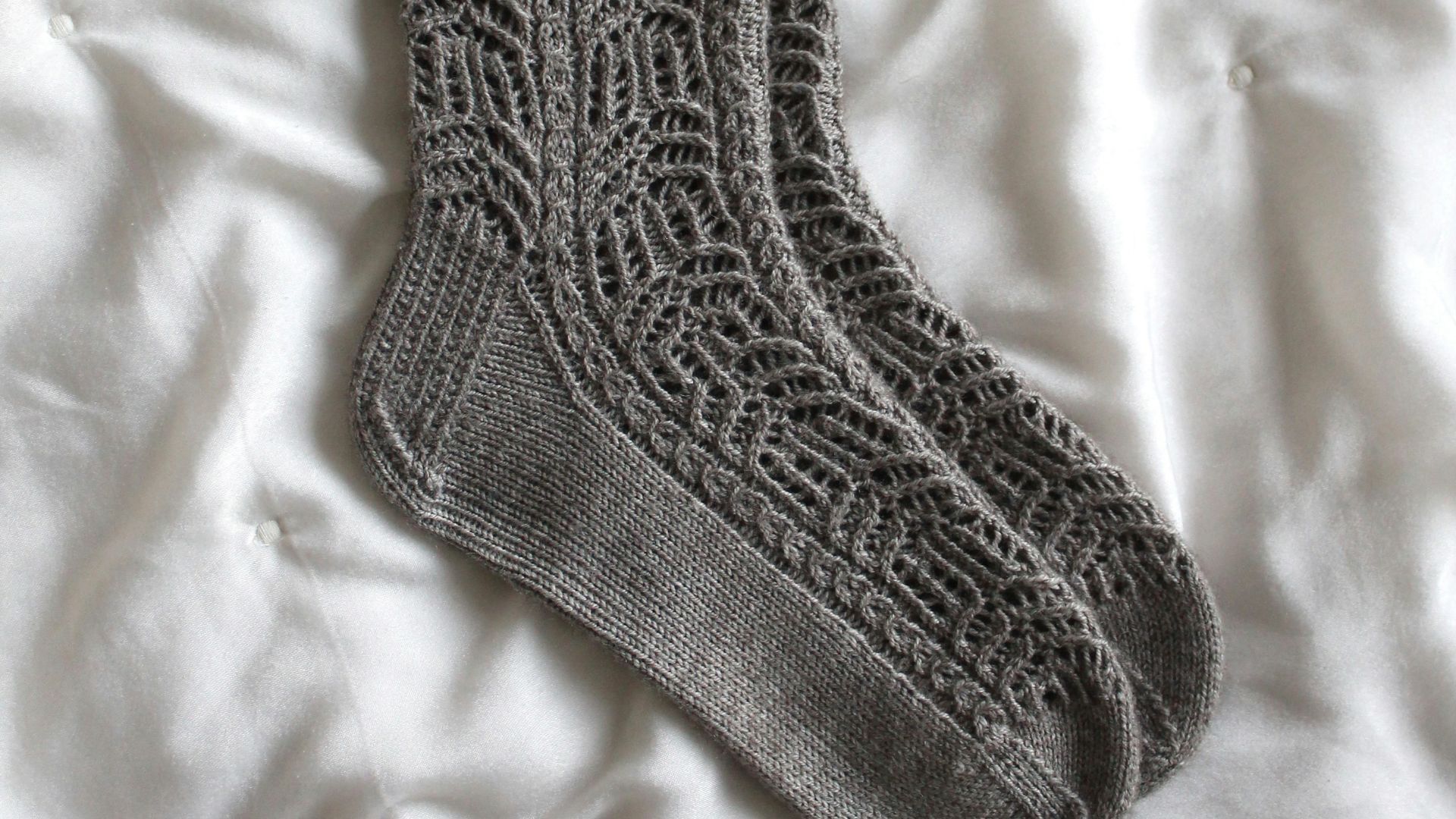 gray sock on white textile
