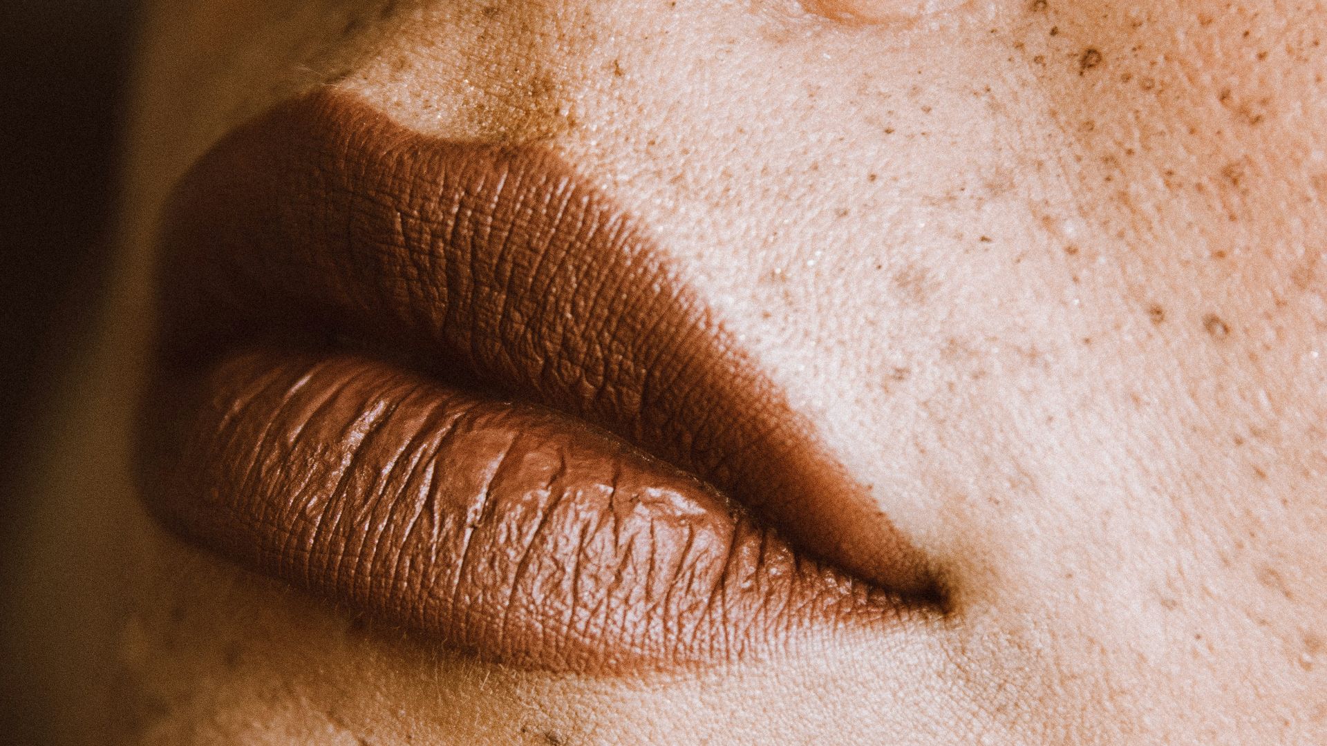 a close up of a woman's face with freckles