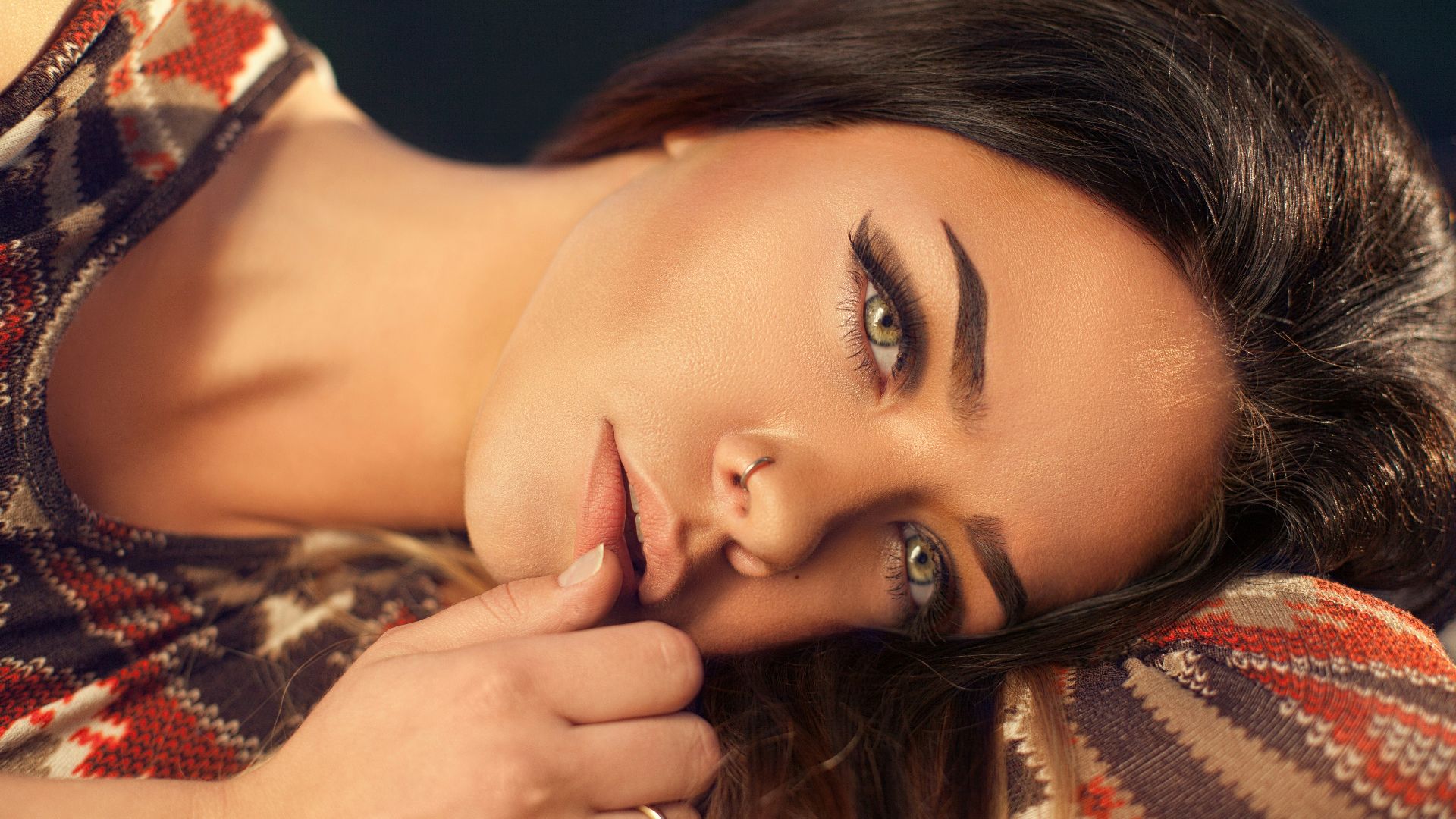 woman wearing red, white, and black aztec top