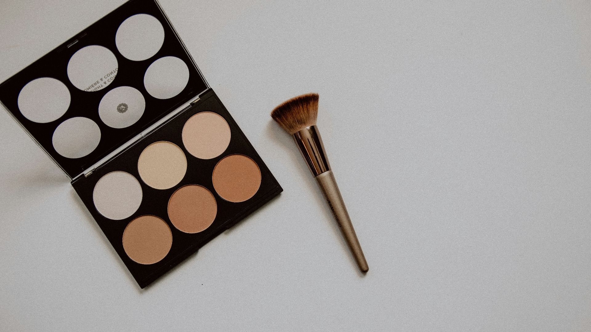 brown and white makeup brush