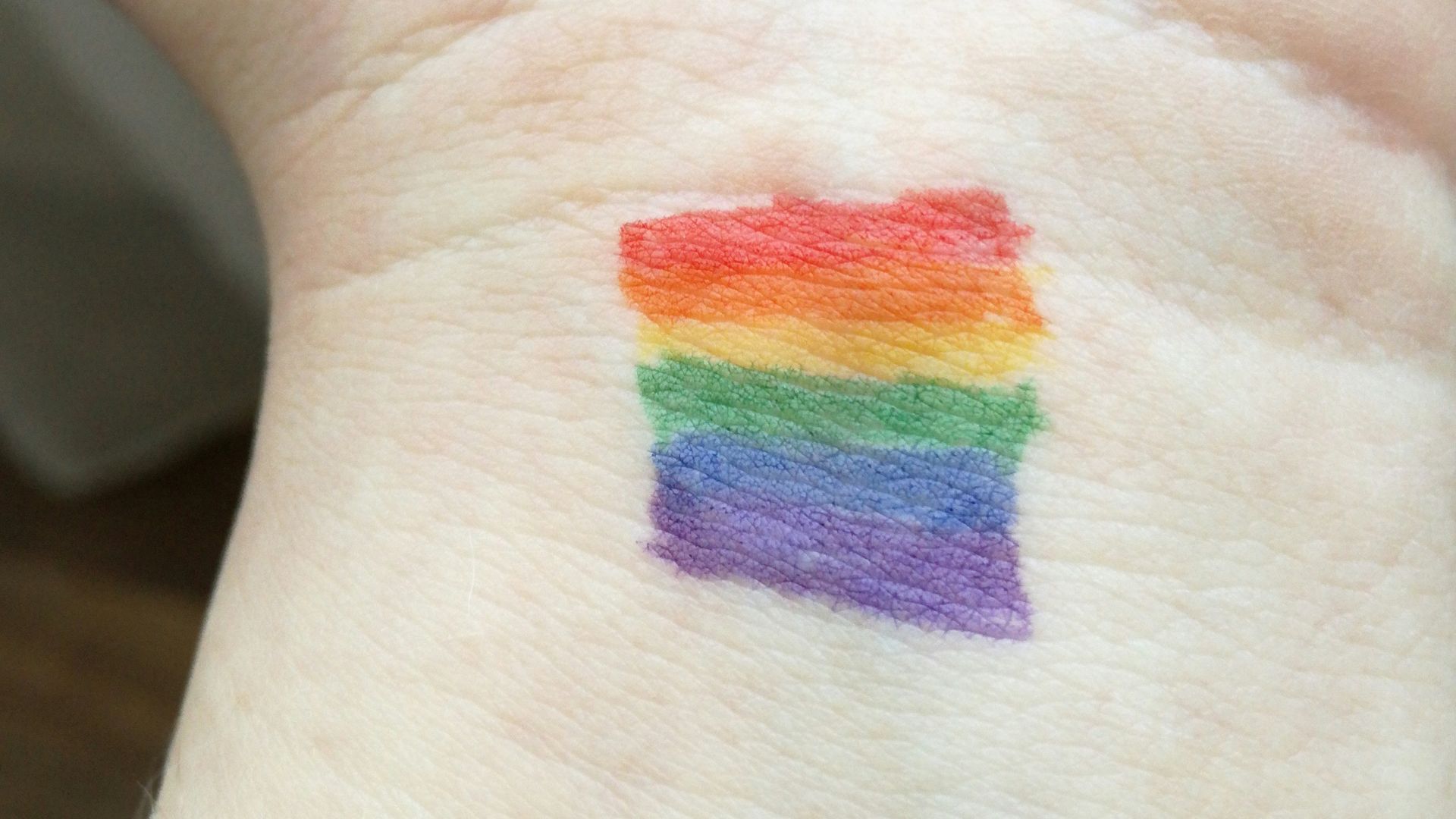 person showing his hands with assorted-color inside room