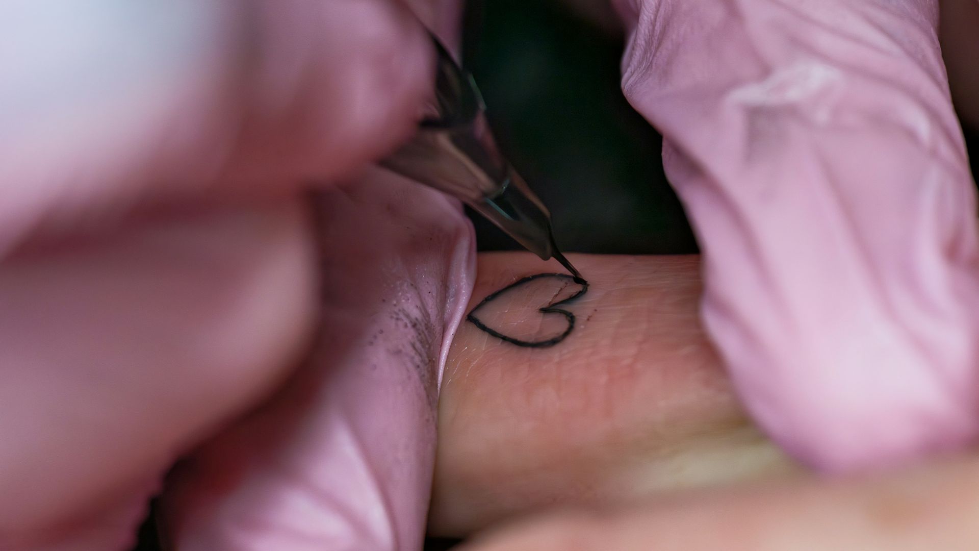 A woman getting a tattoo on her arm