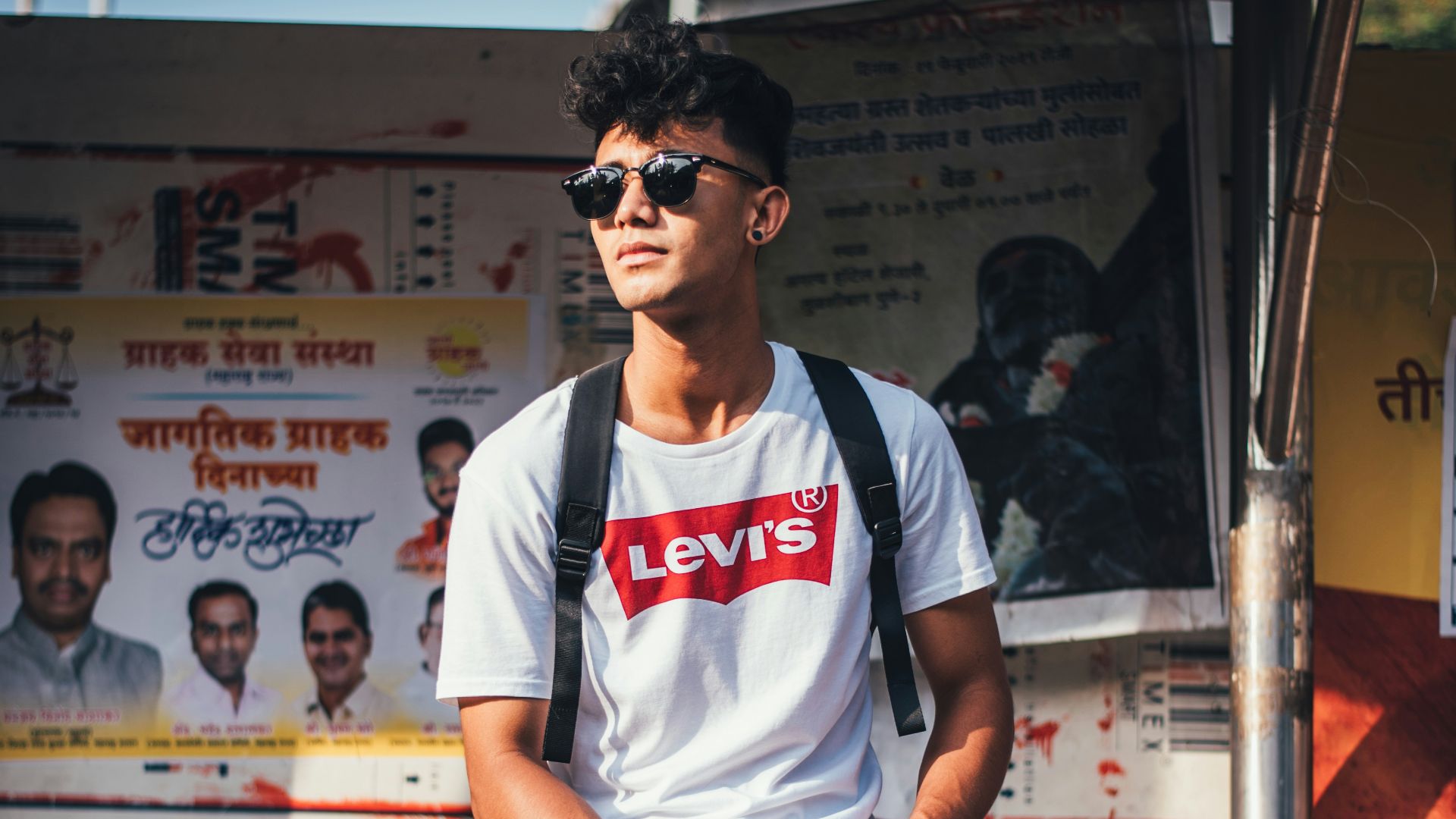 man seated on railings