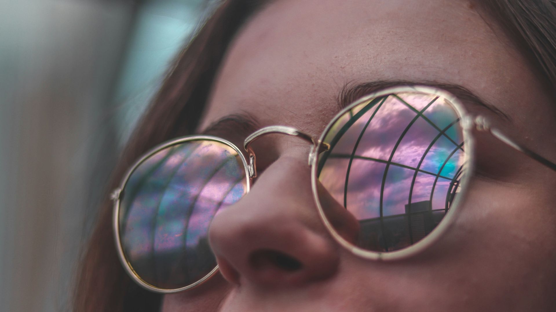 woman wearing sunglasses while smiling