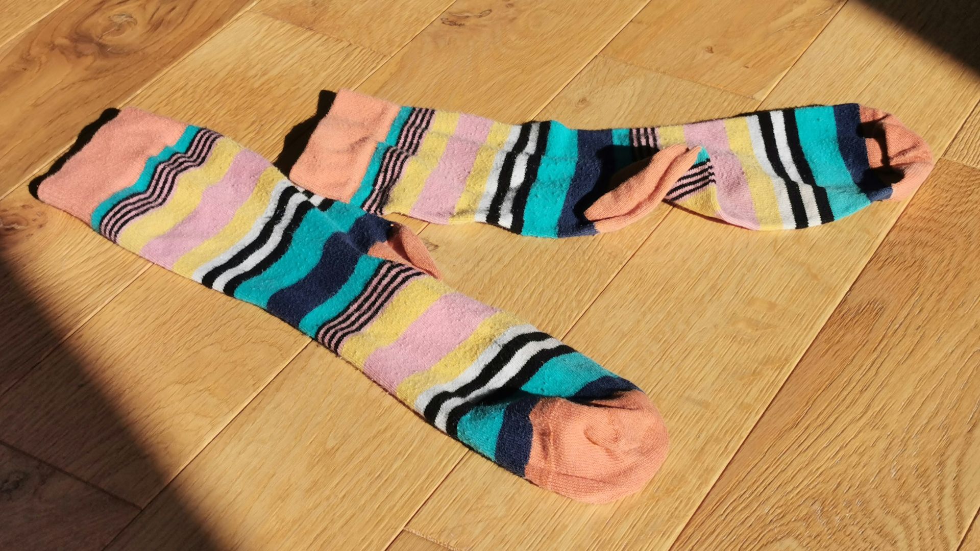 a pair of socks laying on a wooden floor
