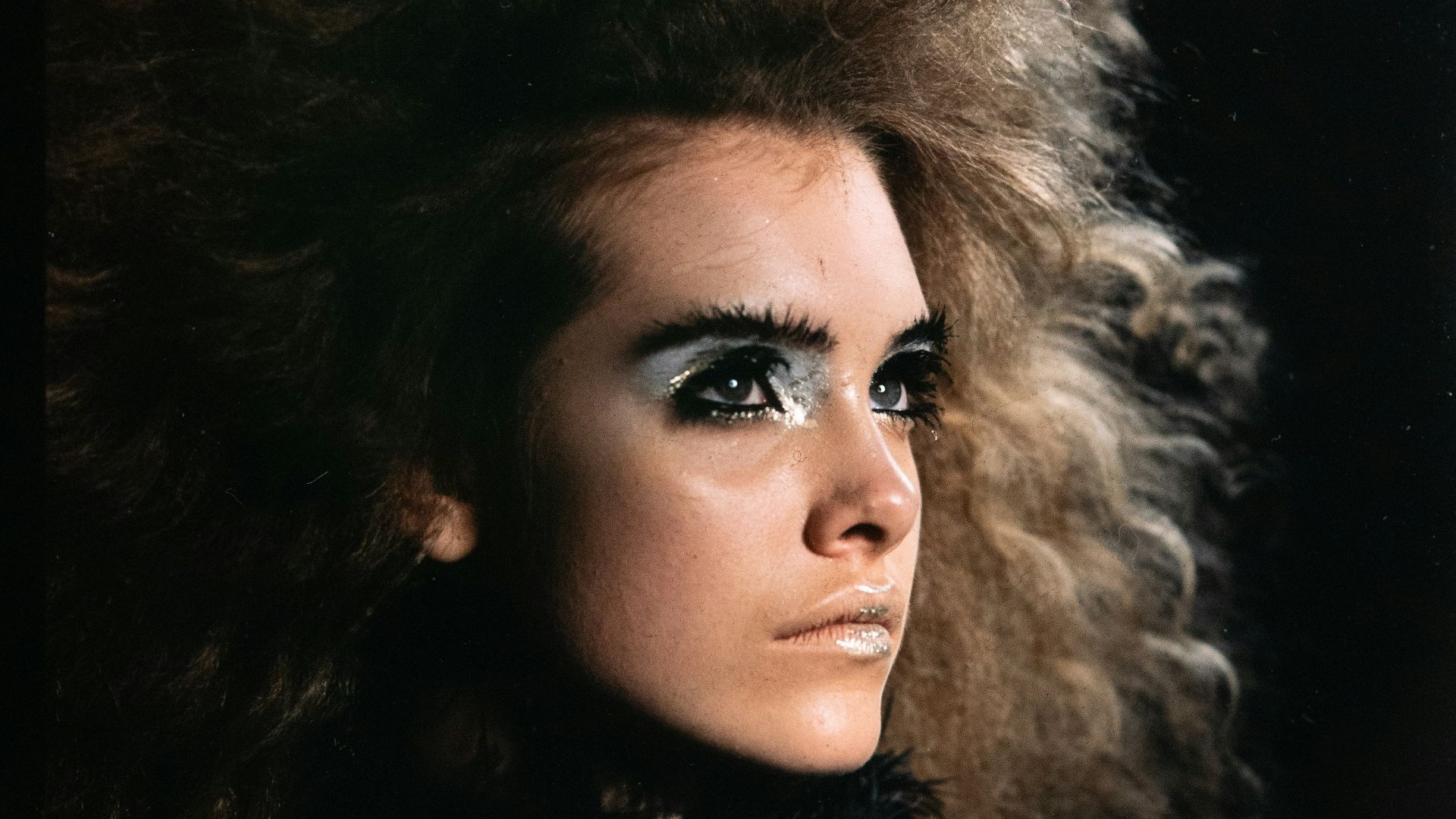 a woman with long hair and black makeup