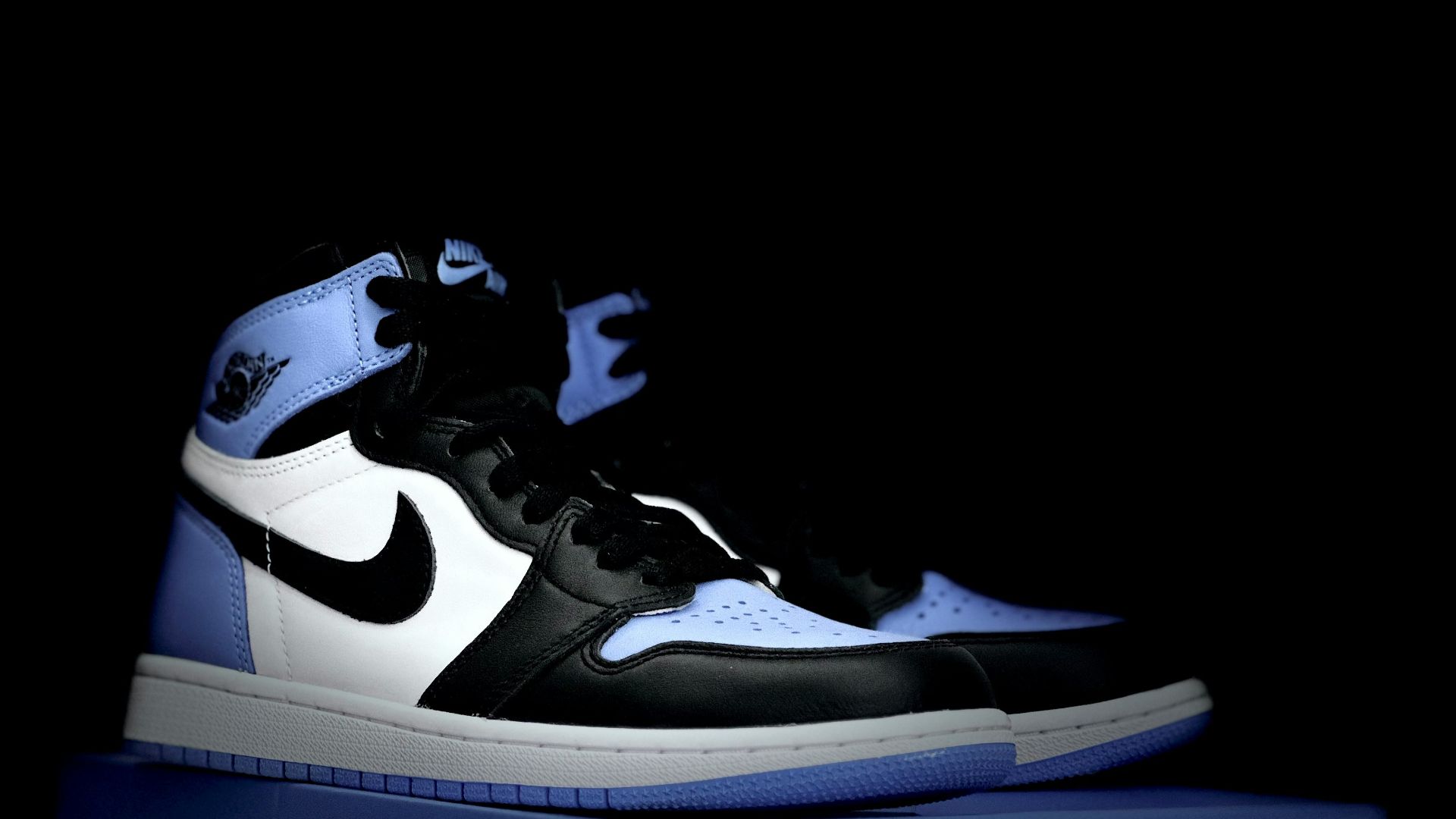 a pair of sneakers sitting on top of a box