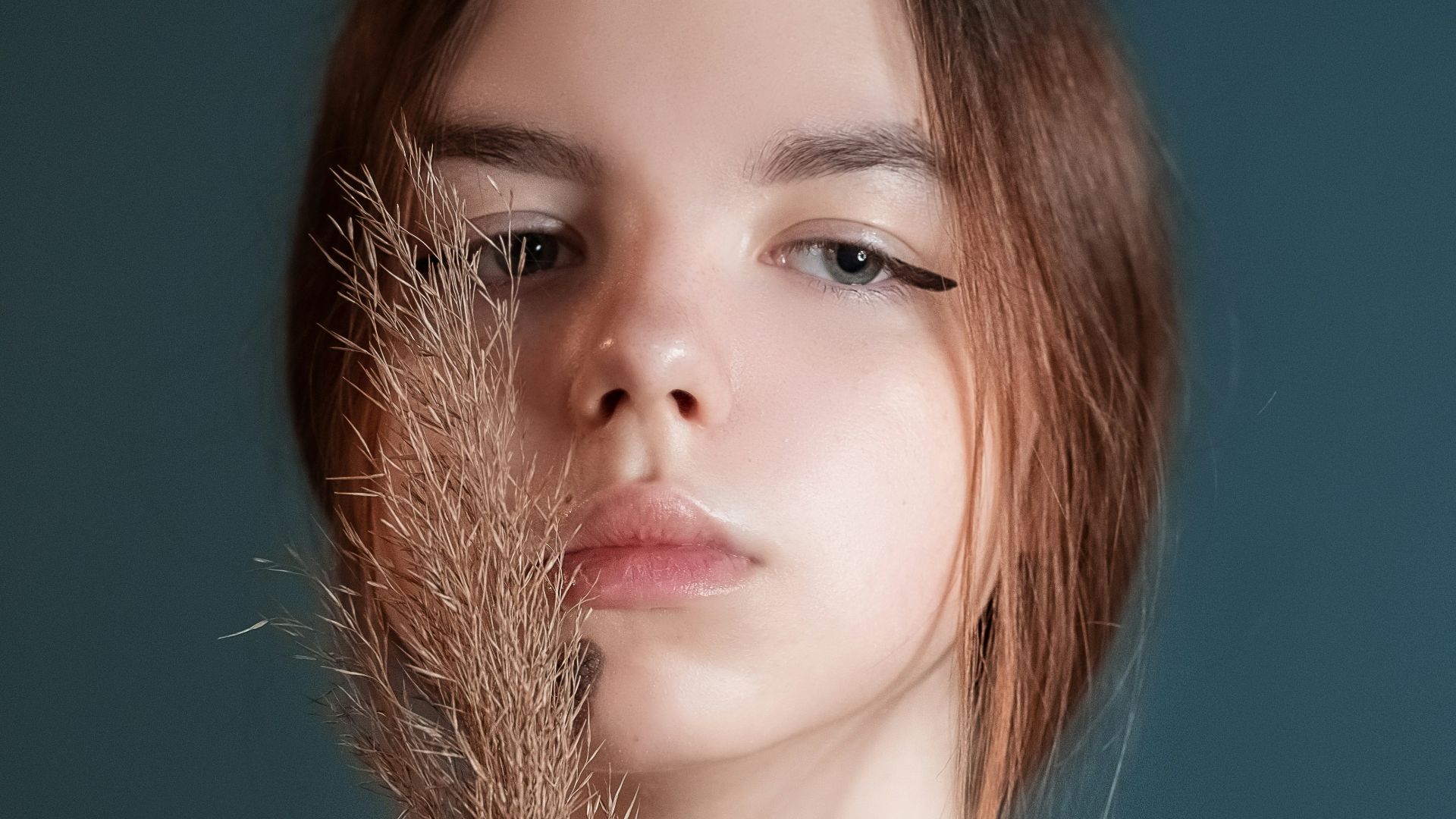 woman with brown hair and silver necklace
