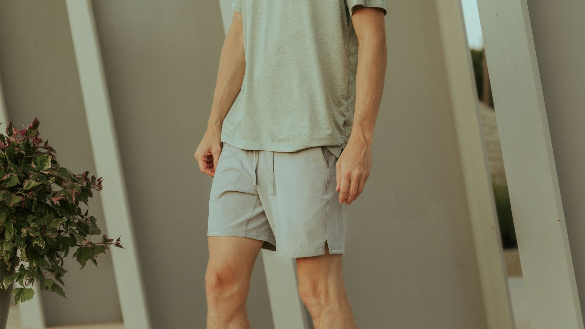 a man standing in front of a plant