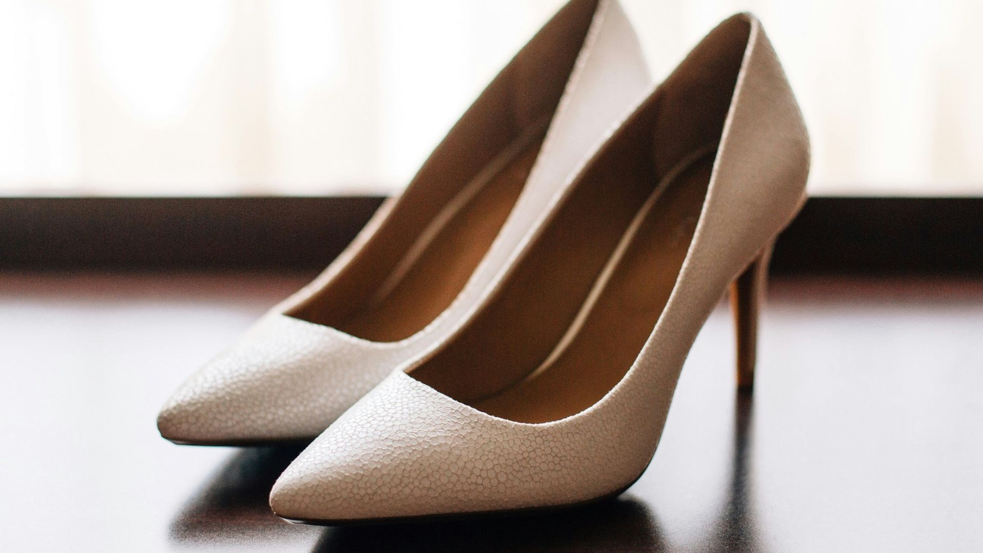 pair of women's brown pointed-toe pumps on board