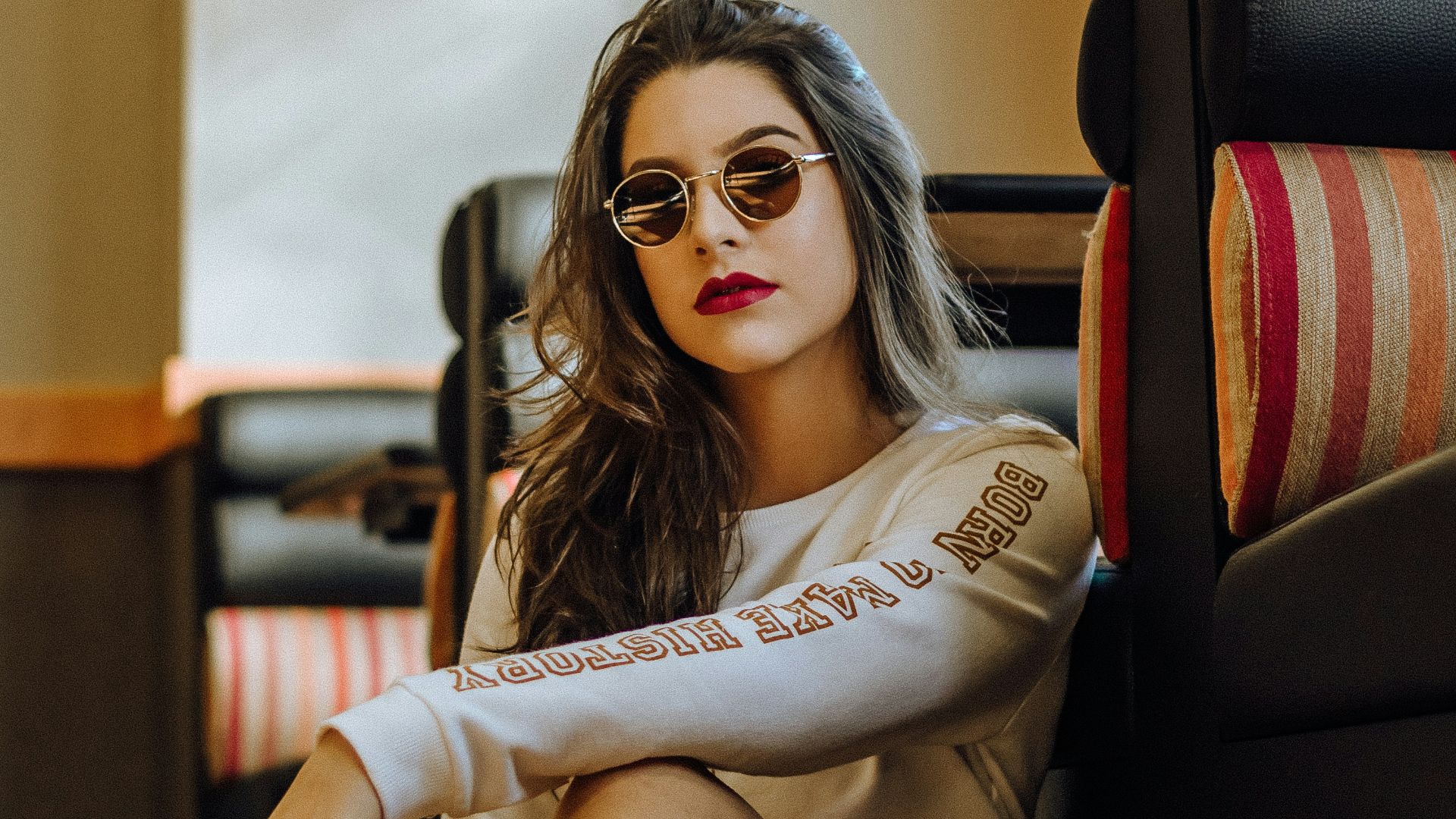 woman sitting near sofa with cross legs