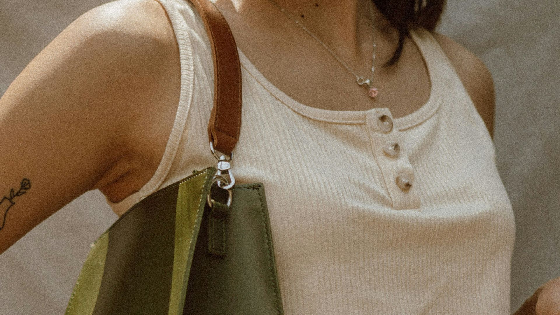 woman in white sleeveless top and white and black plaid skirt
