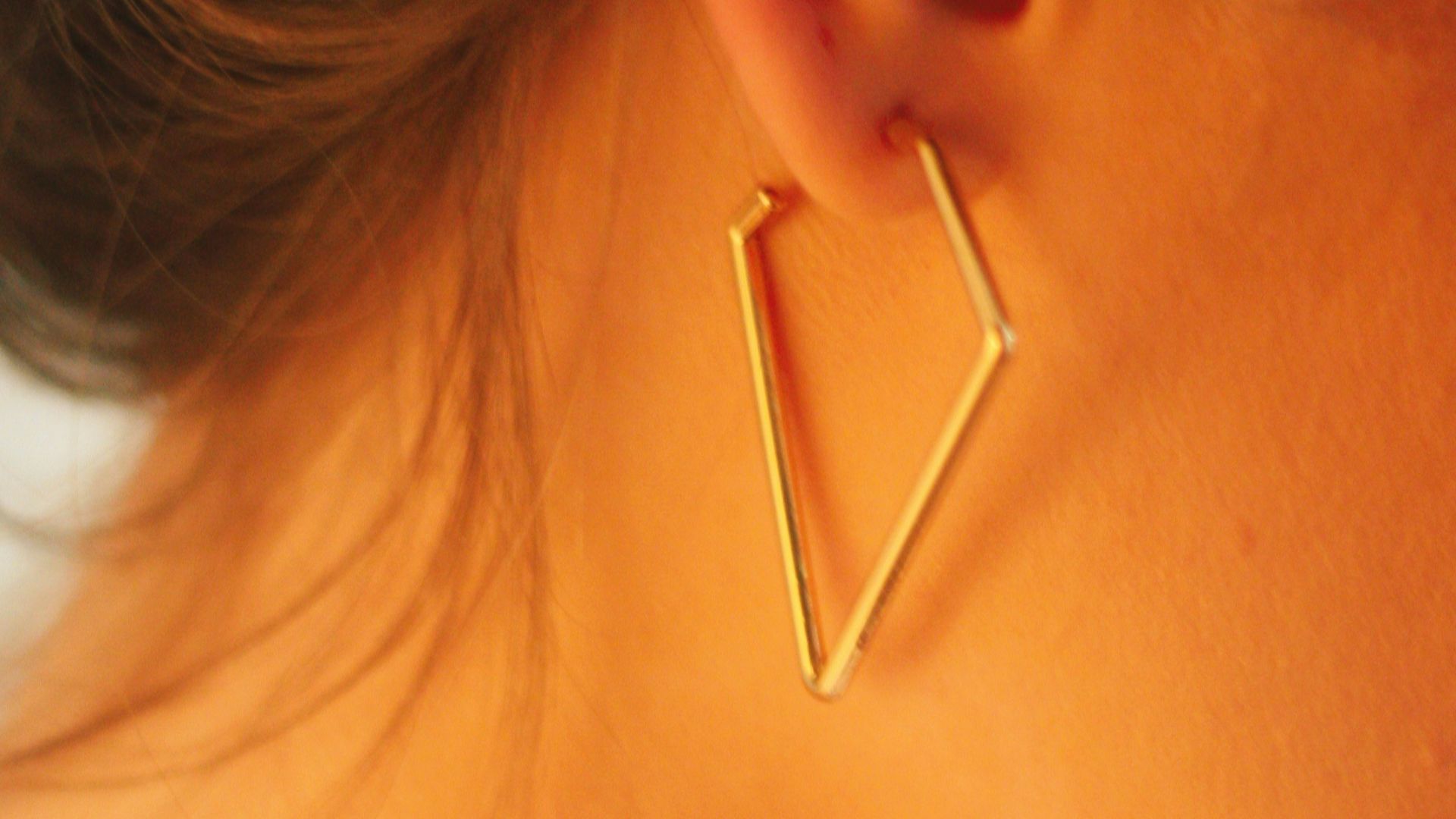 woman with gold hoop earrings