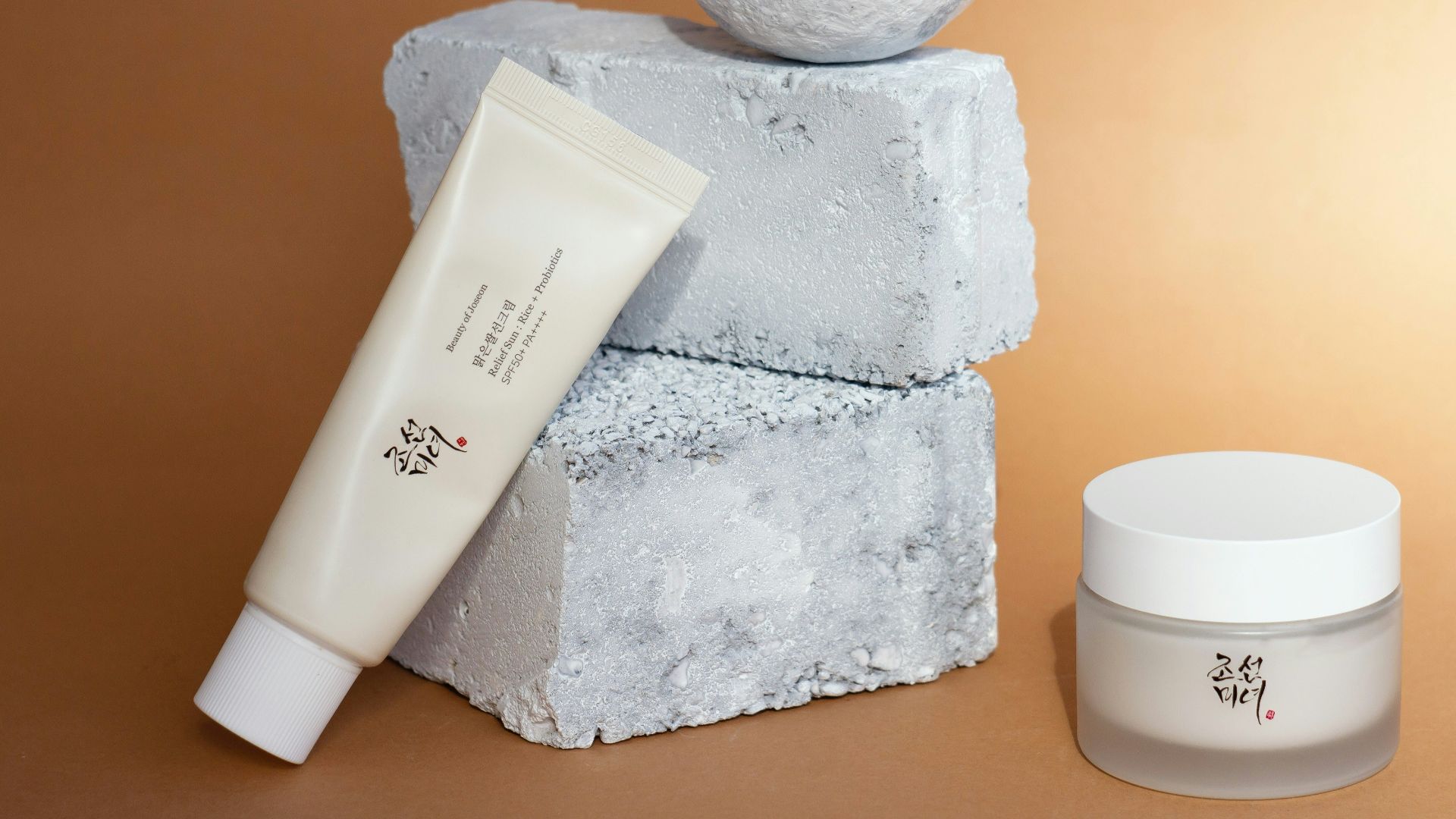 a bottle of lotion, a tube of cream, and a ball of soap