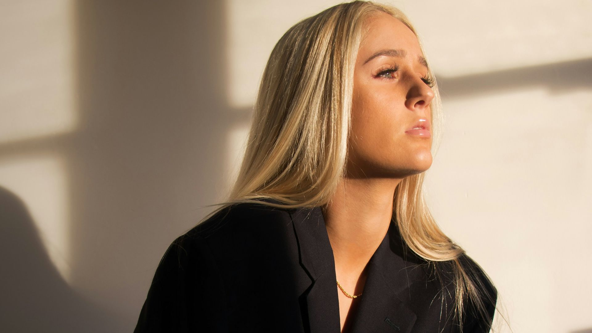 woman sitting on chair while wearing black top