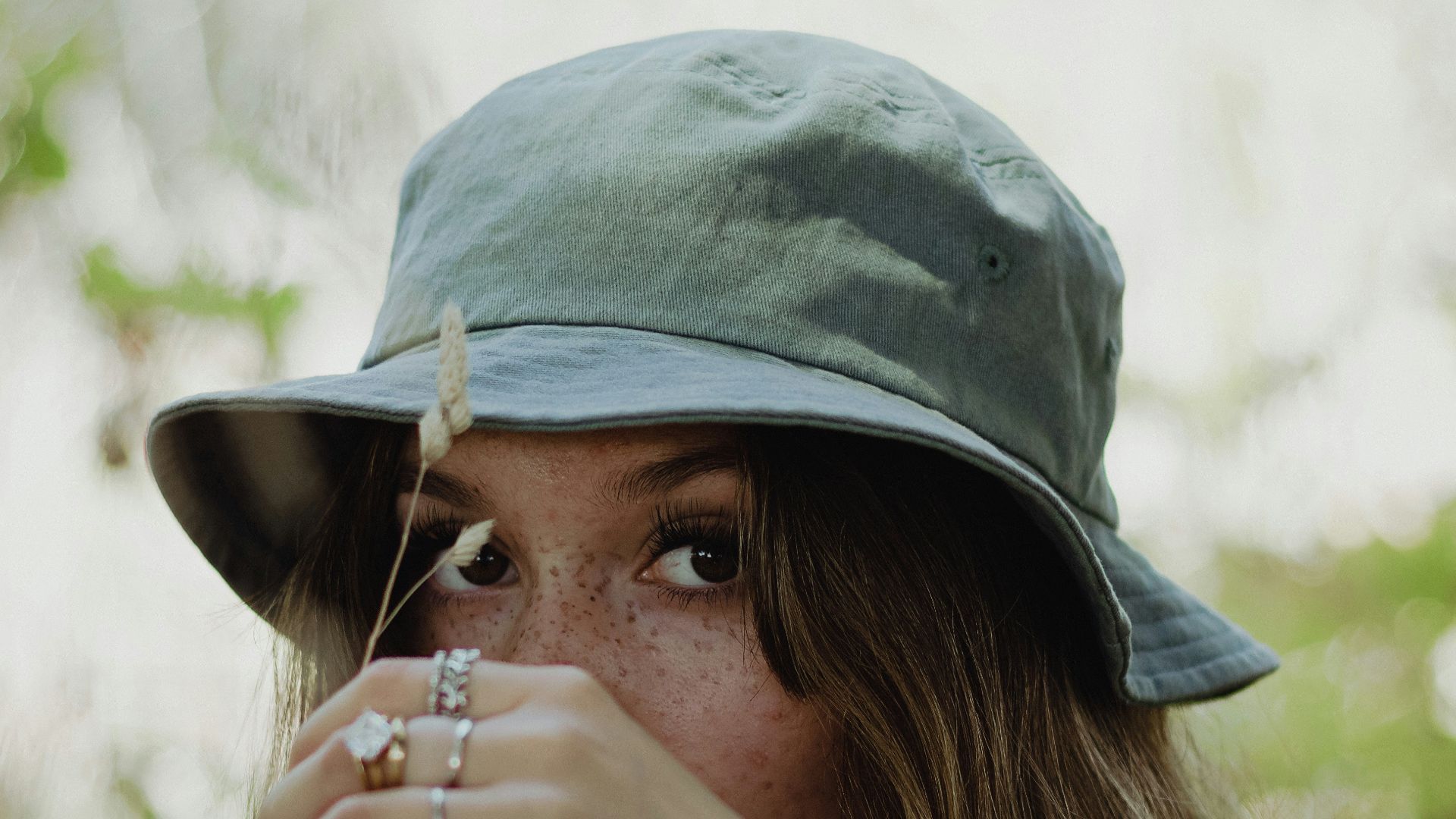 woman in white shirt wearing gray hat