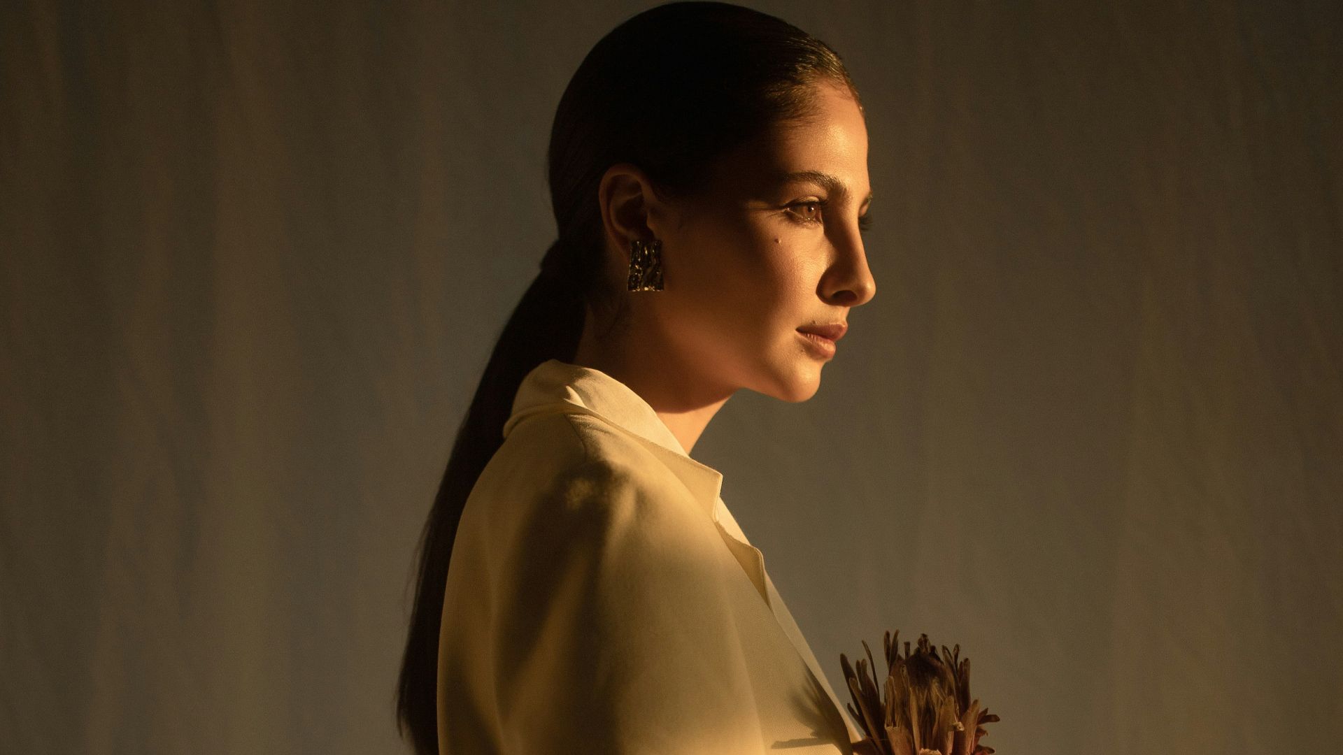 woman holding dried flower