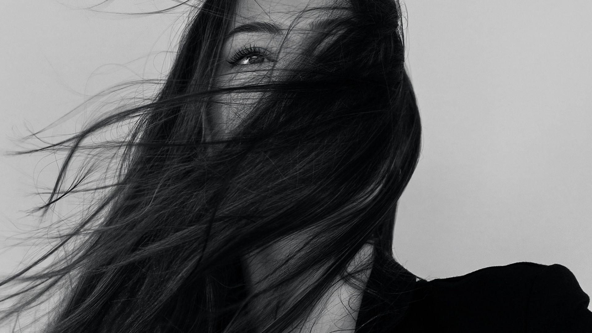 grayscale photography of woman wearing long-sleeved shirt