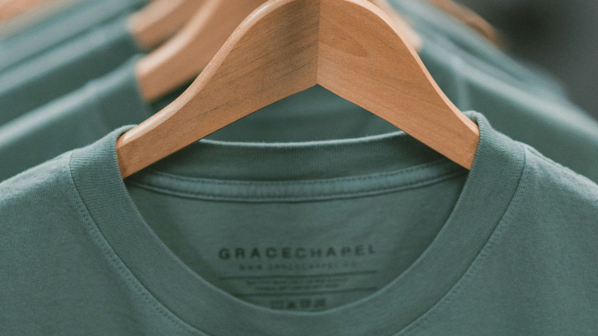 selective focus photography of green crew-neck shirt