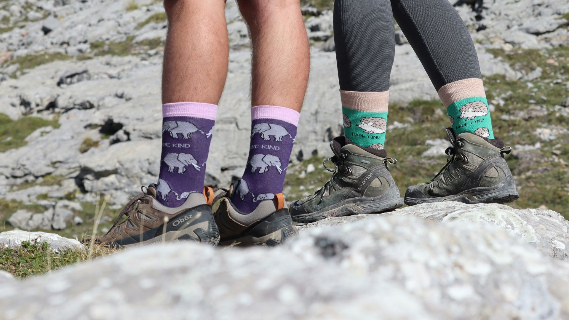 A couple of people standing on top of a mountain