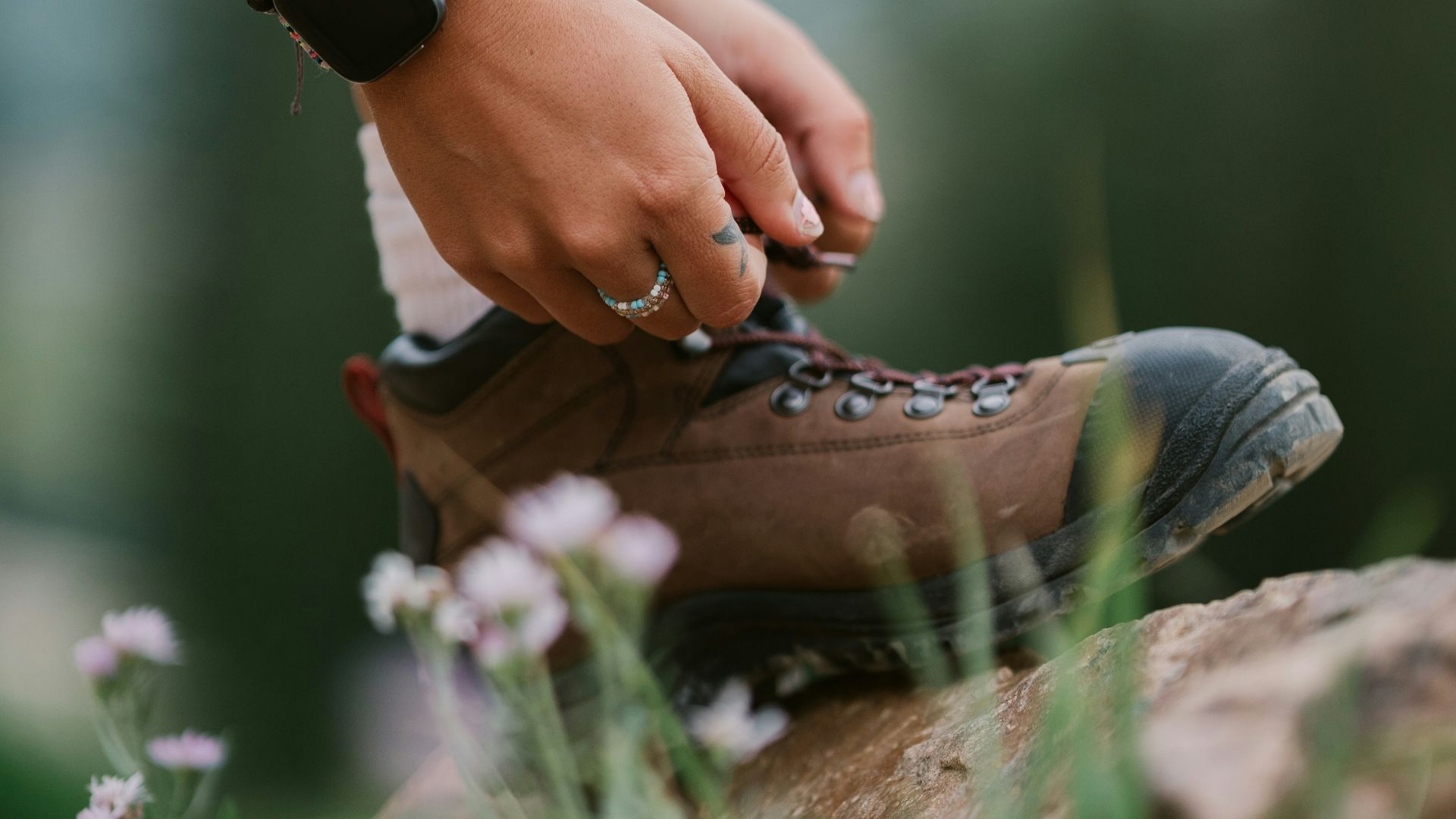 a person's hands holding a shoe