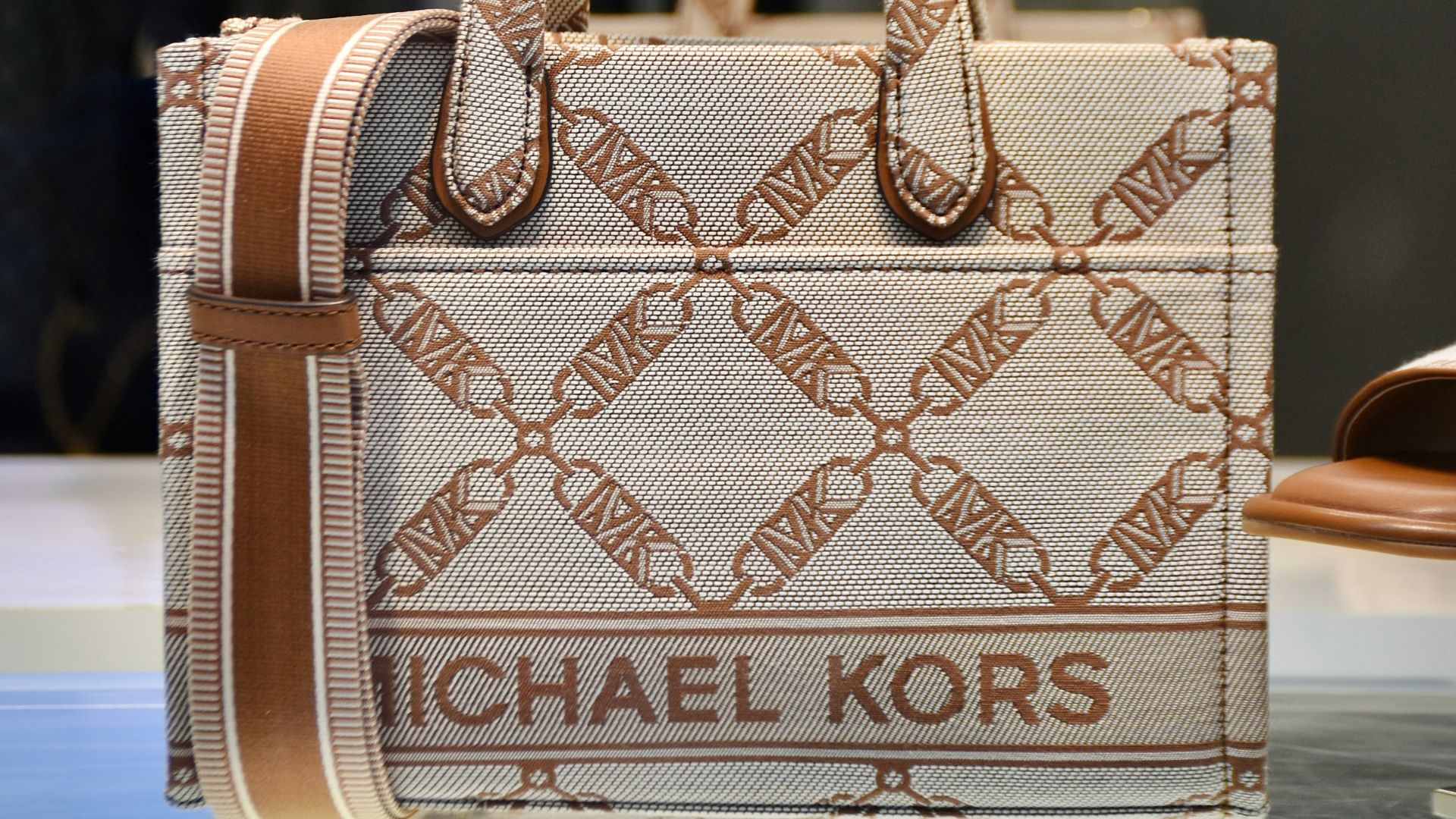 a michael kors bag on display in a store window