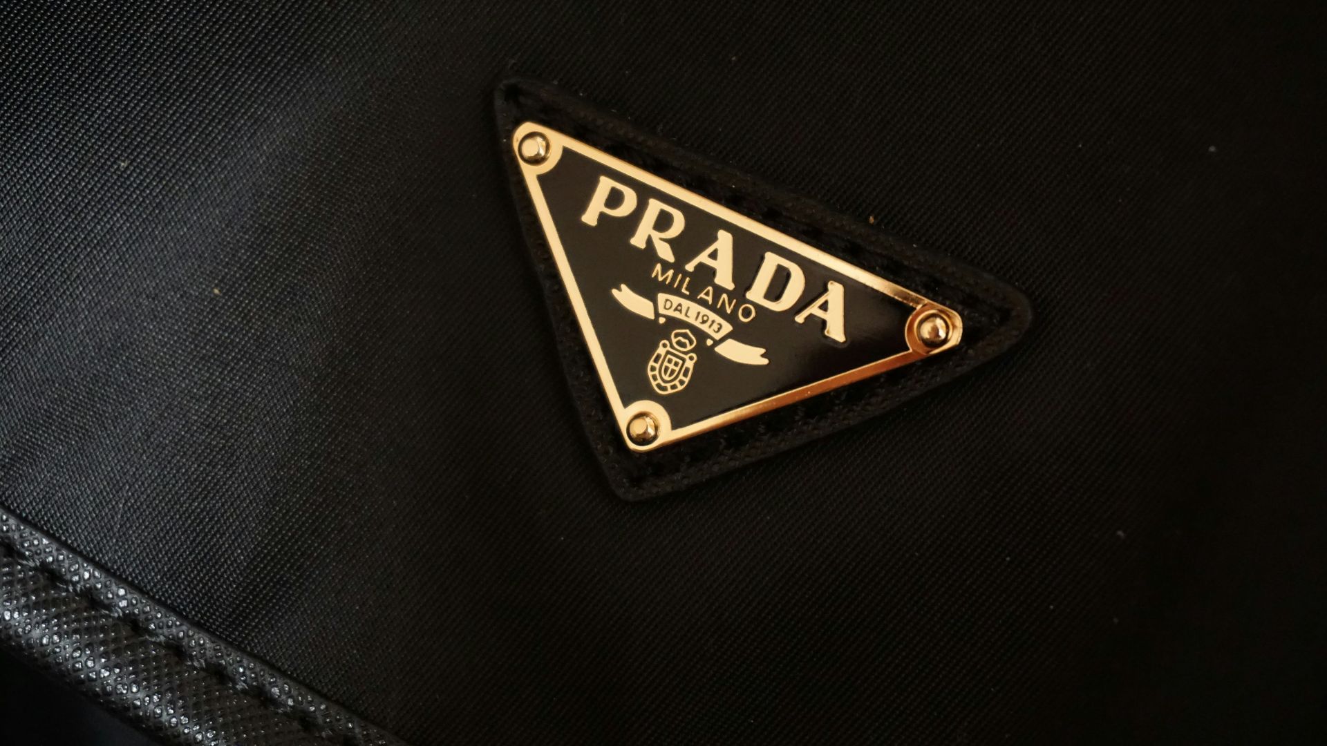 a prada logo on a black jacket