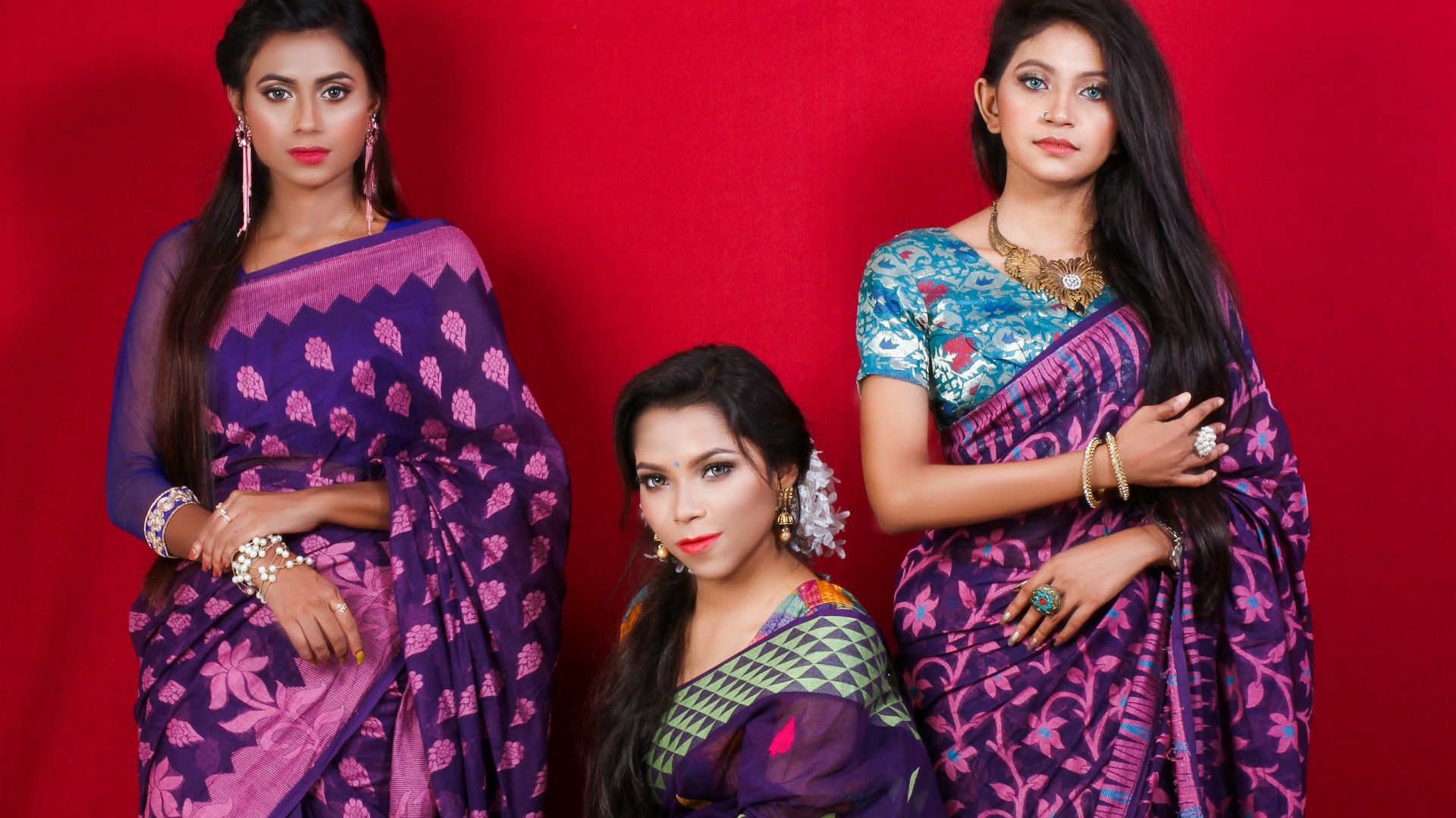 3 women in purple and pink sari