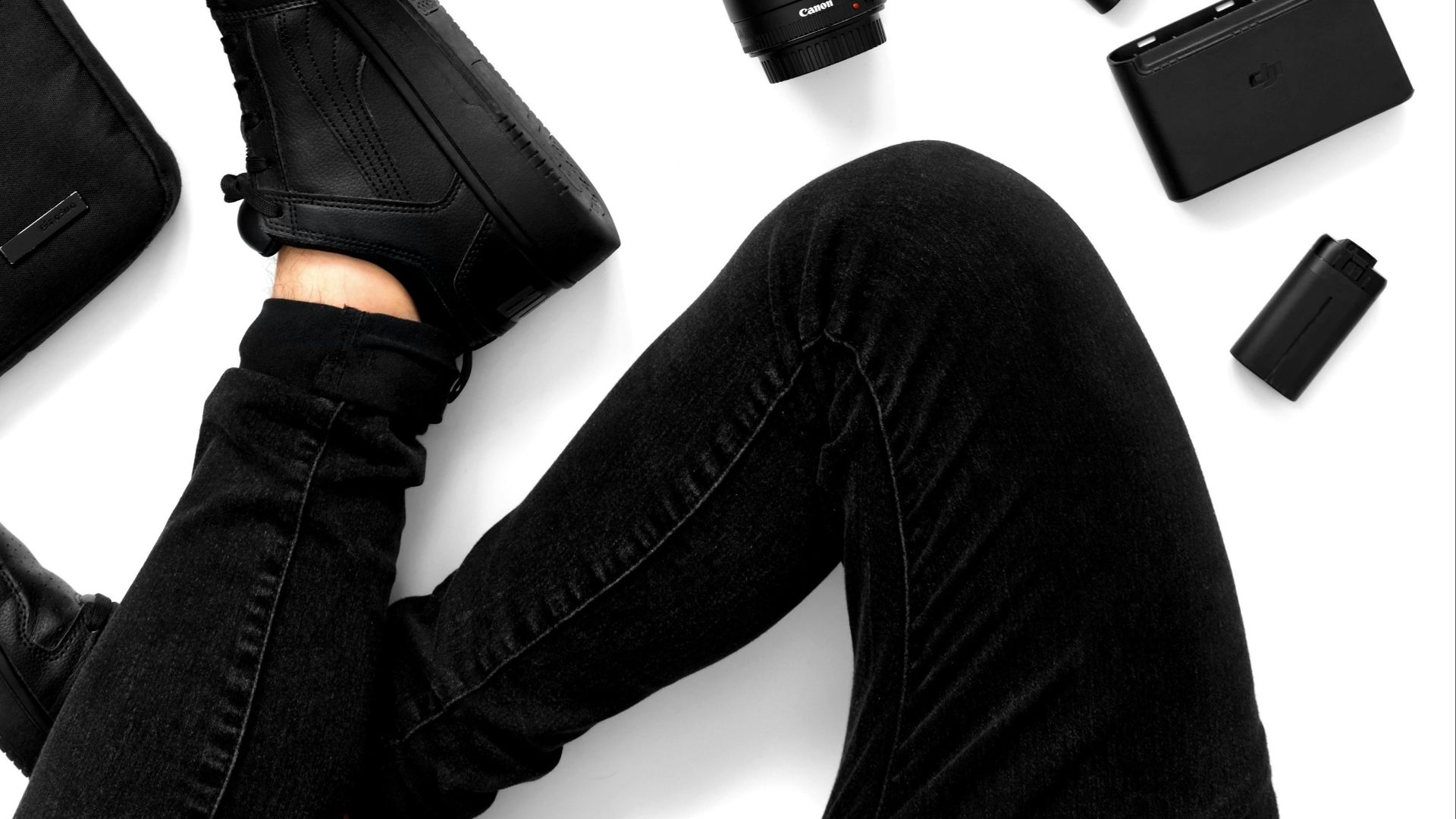 a person laying on the ground surrounded by electronics