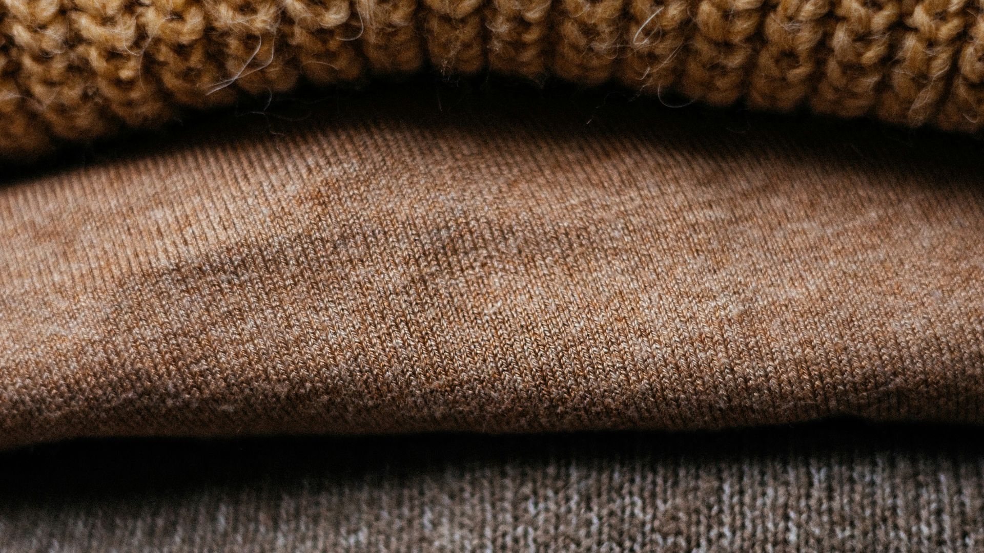 a pile of sweaters stacked on top of each other