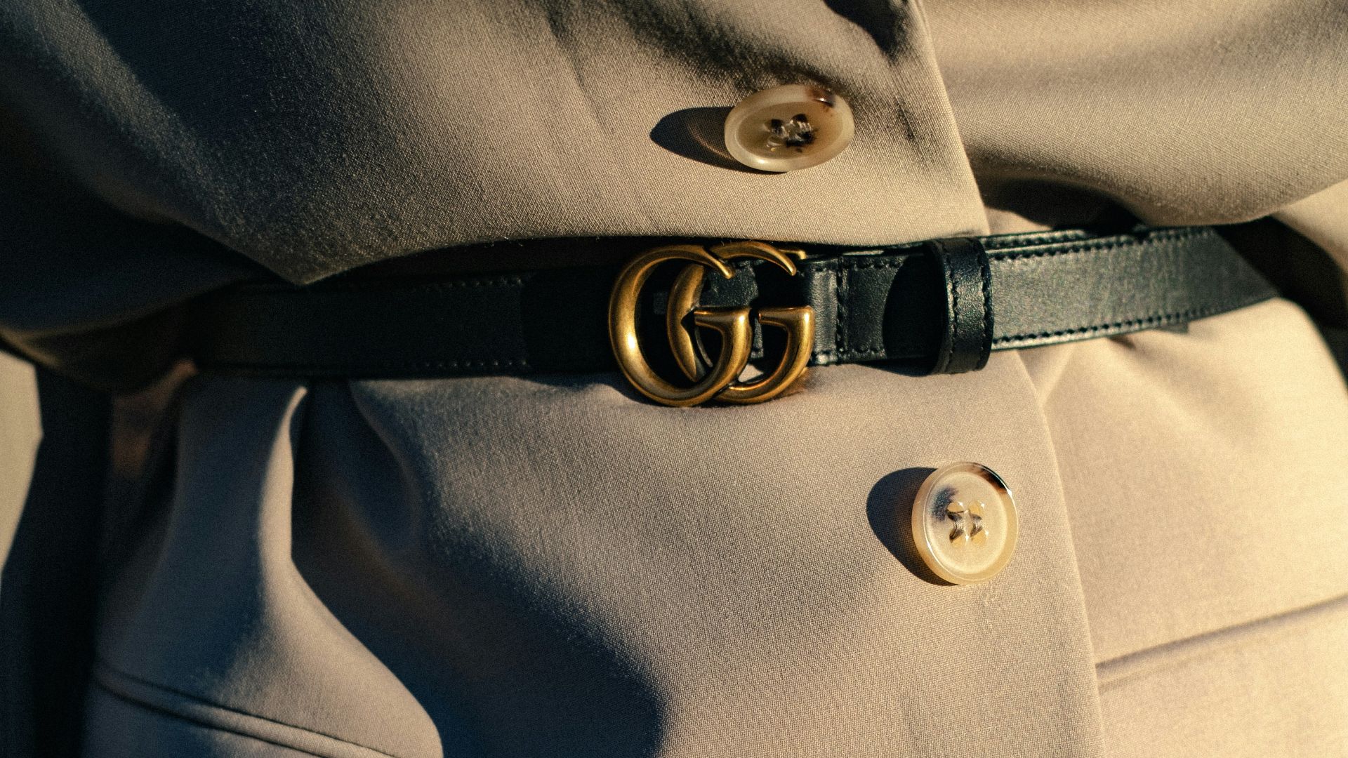 black leather belt on gray textile