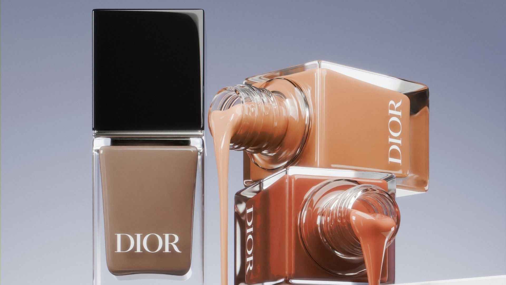 A bottle of dior's nail polish next to a bottle of dior