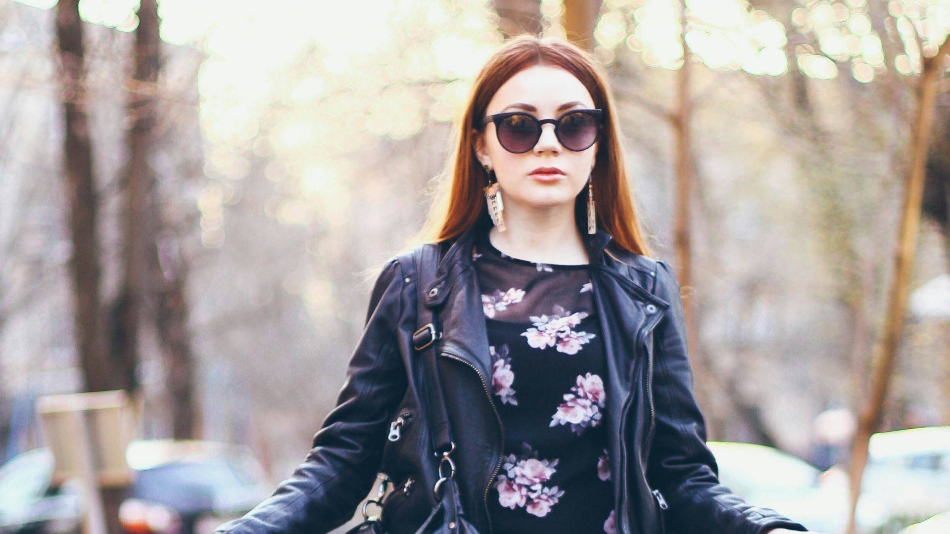 woman in black and white floral long sleeve shirt and black pants wearing sunglasses