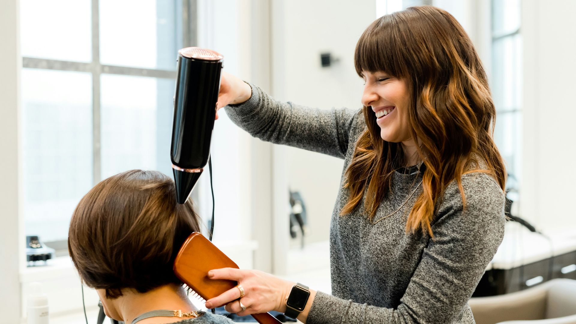 woman holding hair dryer