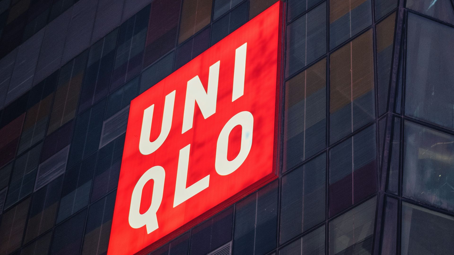 a tall building with a red sign on the side of it