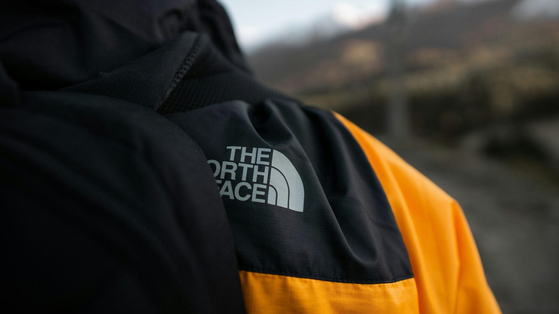 person in black and yellow jacket