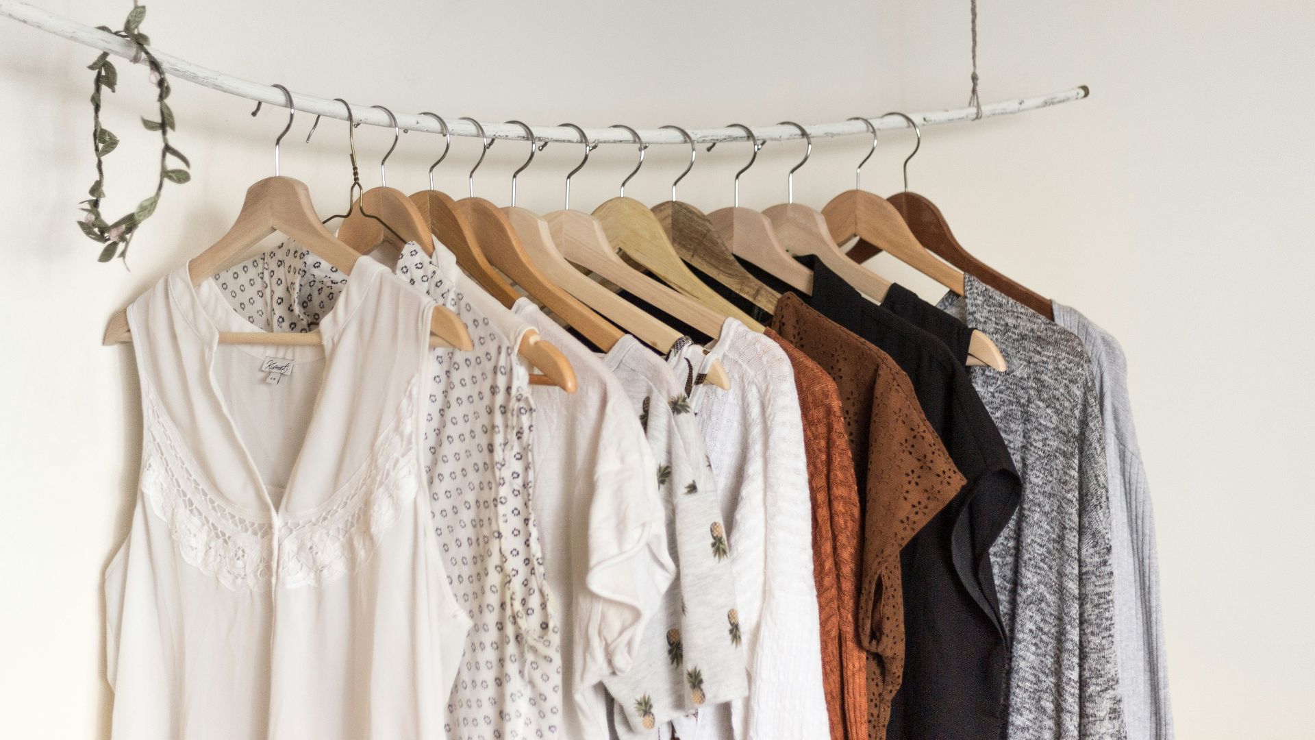 assorted clothes in wooden hangers