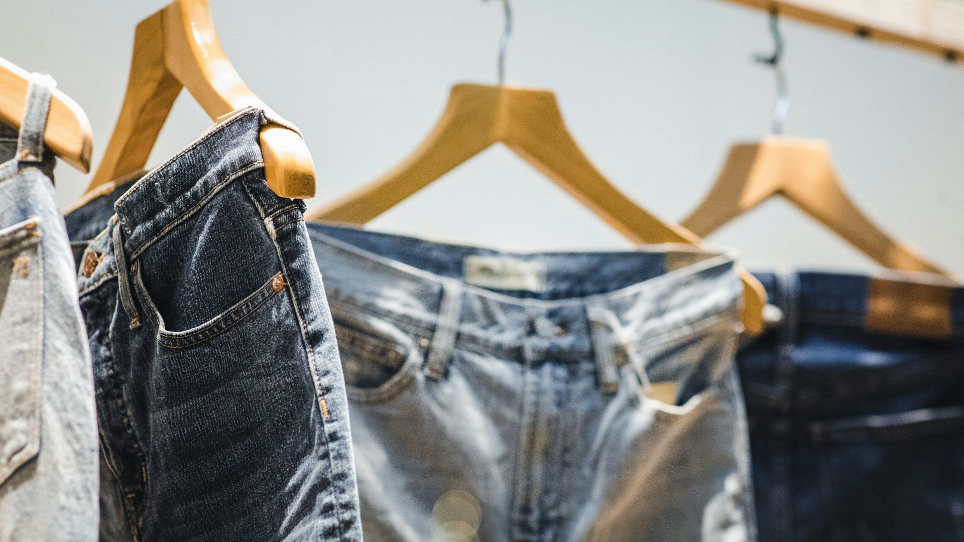 selective focus photography of hanged denim jeans