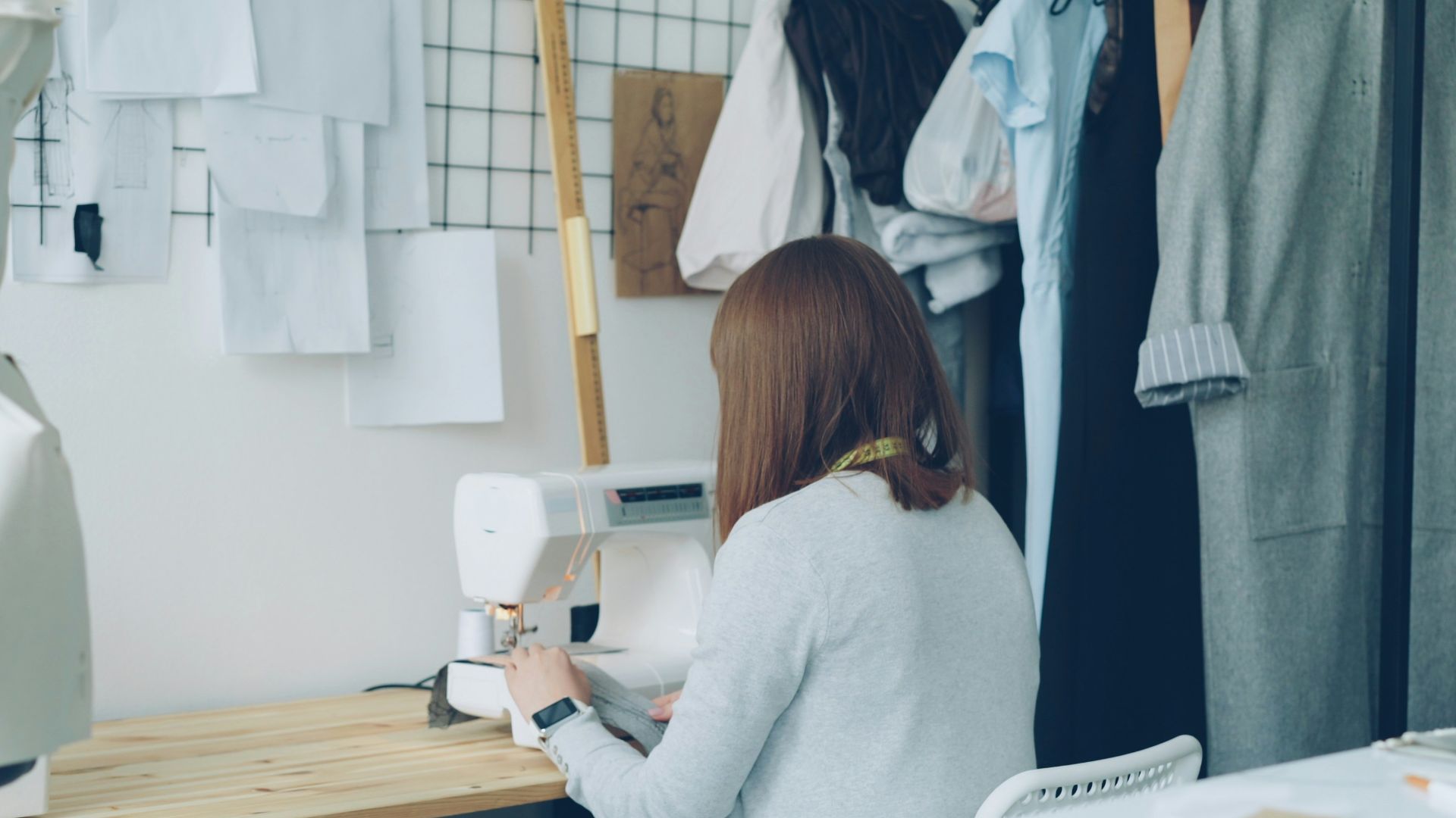 A seamstress is working in her fashion studio.