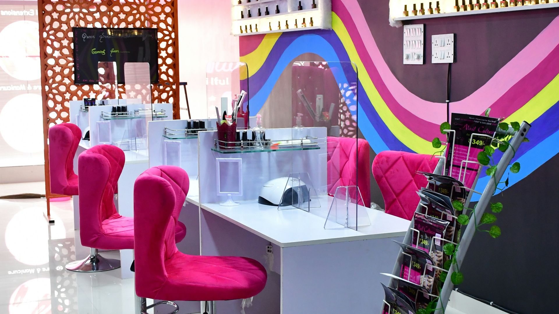 a pink chair in a room with a table and chairs