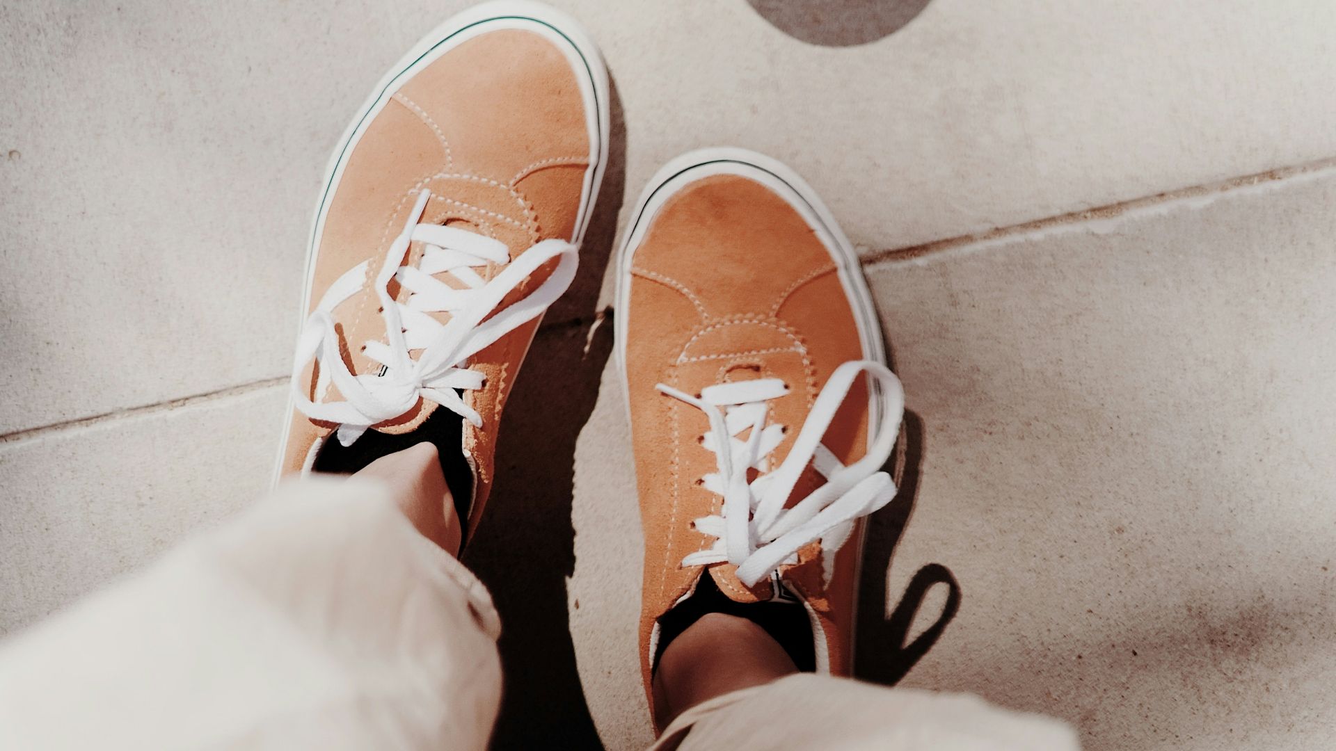person wearing brown and white sneakers