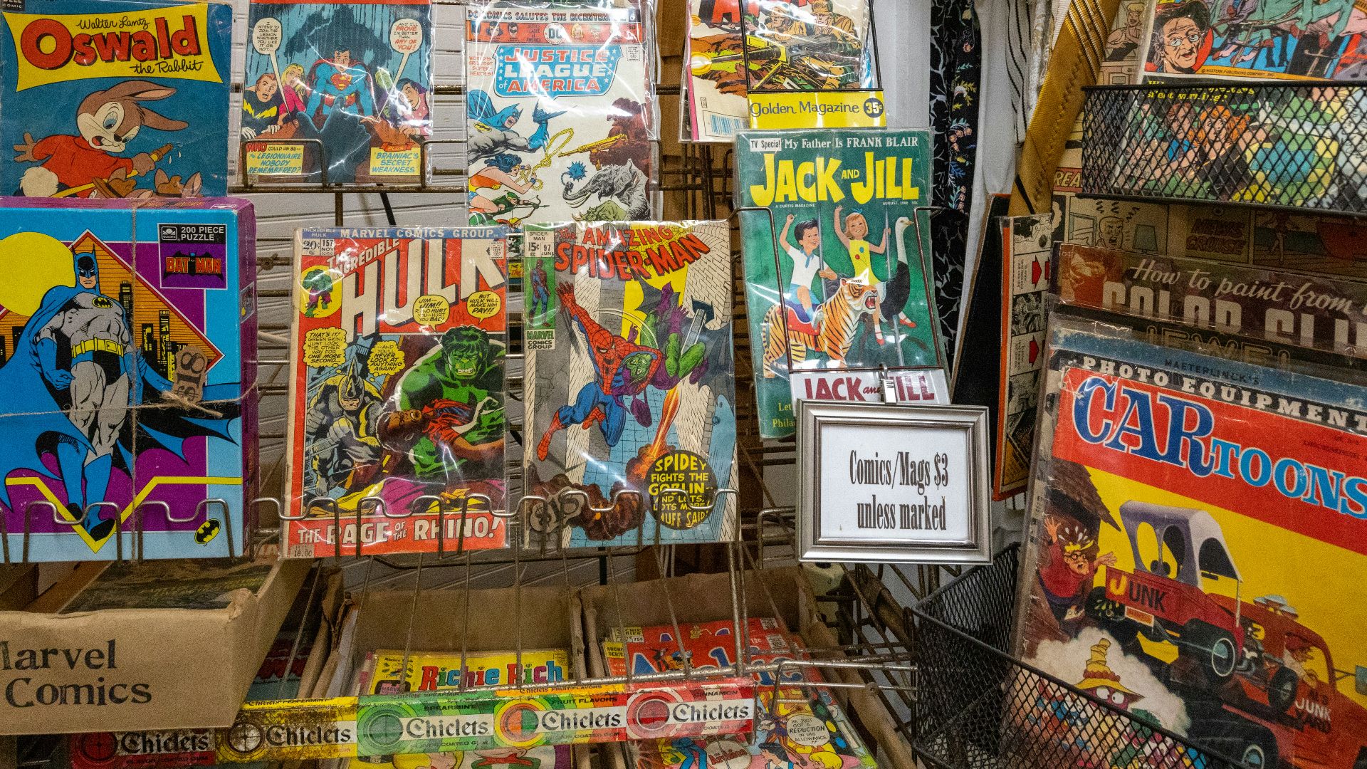 a bunch of comics are on display in a store