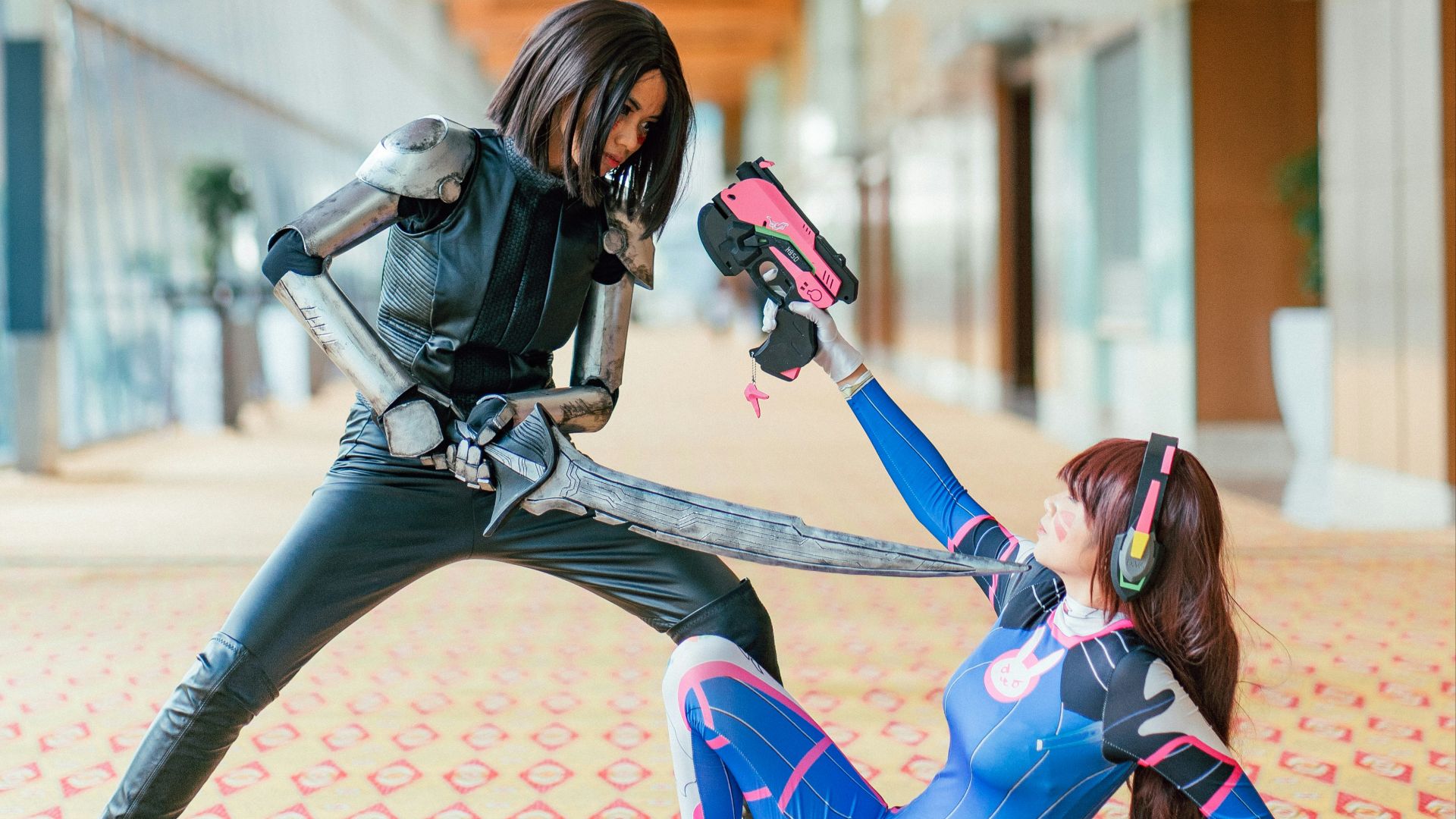 woman pointing sword to another woman
