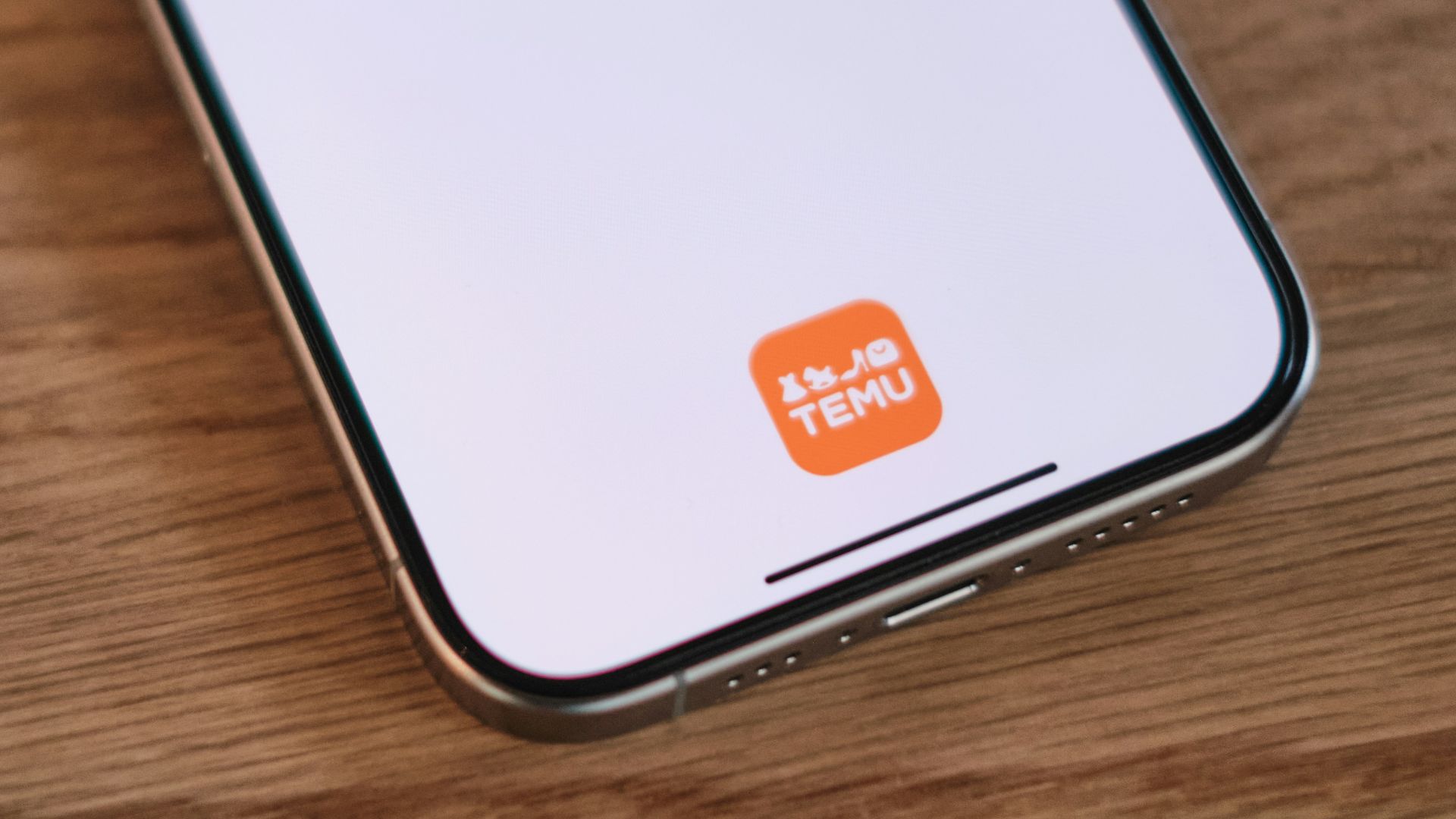 A cell phone sitting on top of a wooden table