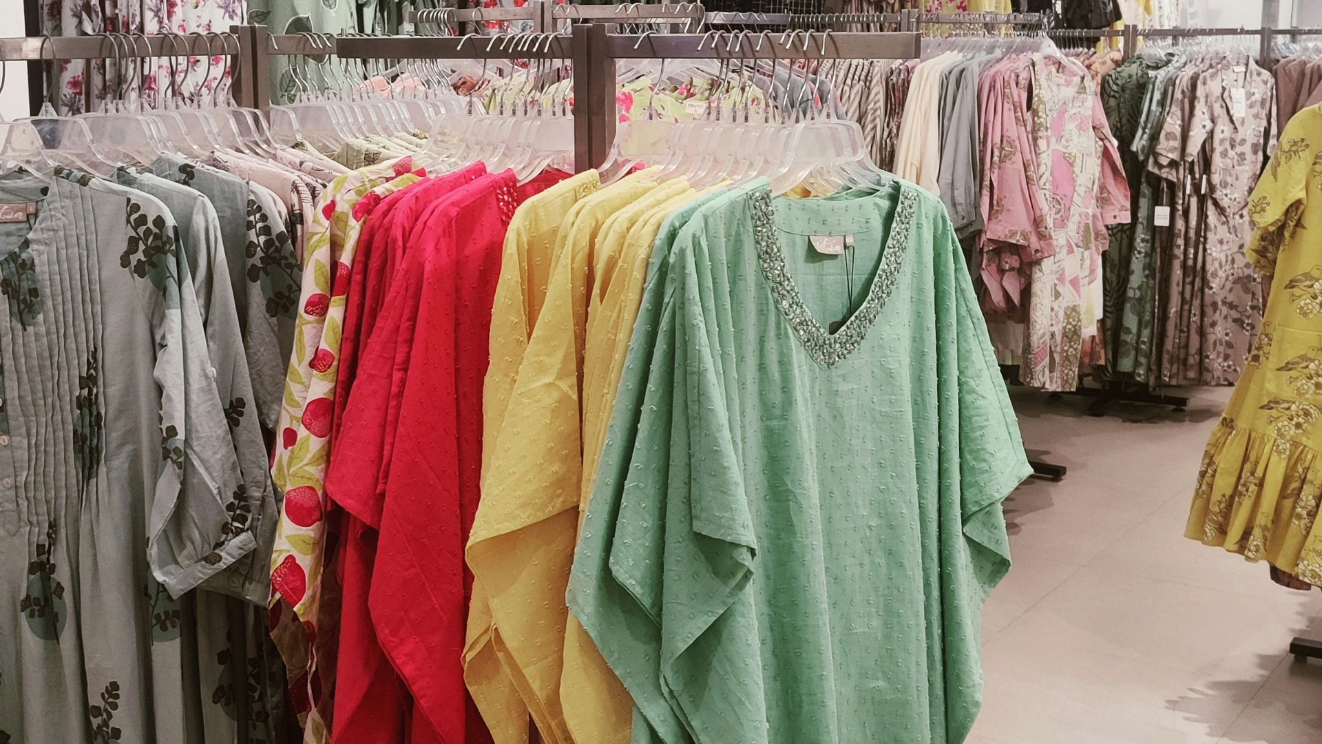 a store with a variety of clothes on the racks